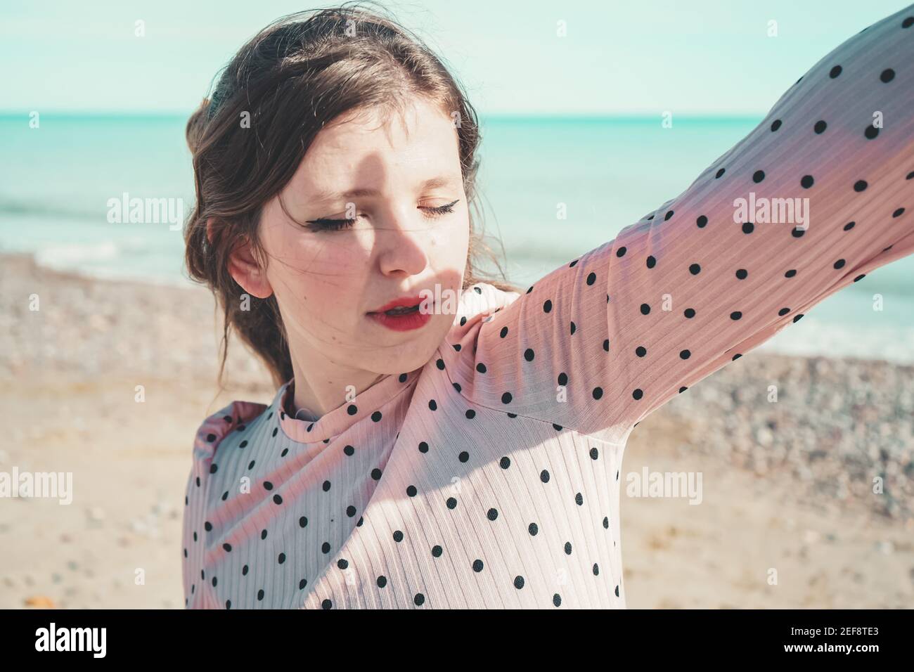 Young woman wearing a pink dress at the beach Stock Photo - Alamy