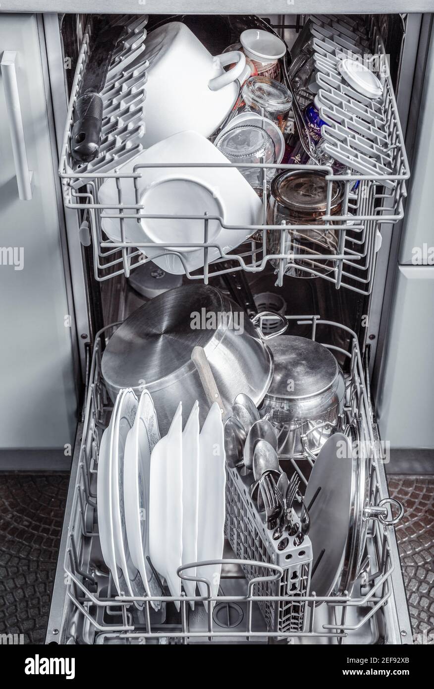 Clean dishes and utensils in an open dishwasher Stock Photo - Alamy