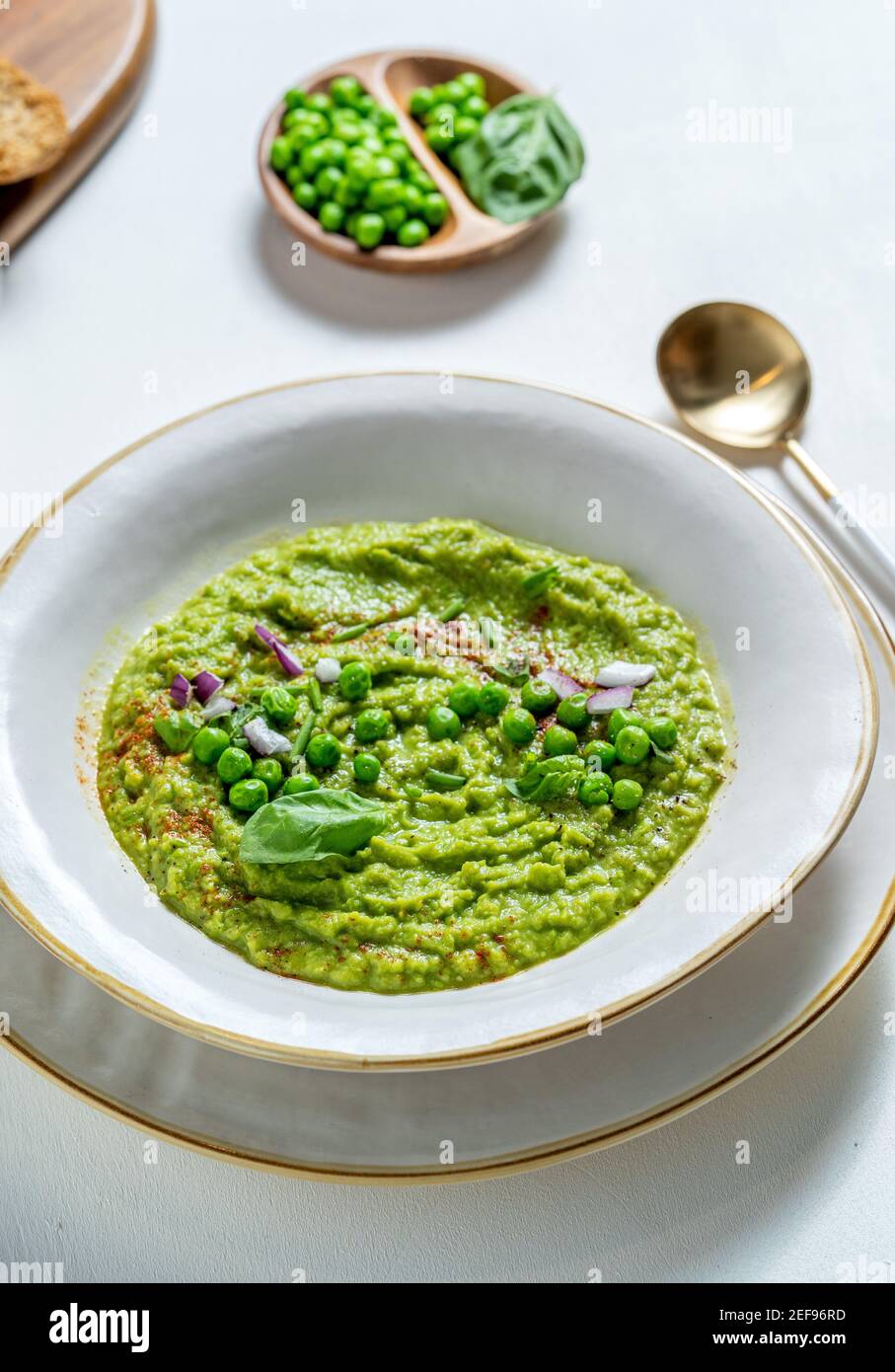 Creamy soup of green peas in a plate Stock Photo