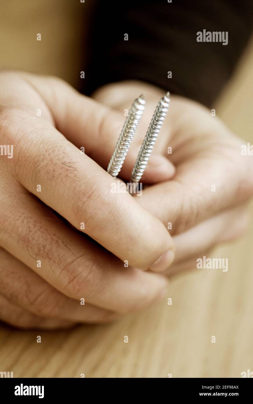 Hand holding screws hi-res stock photography and images - Alamy