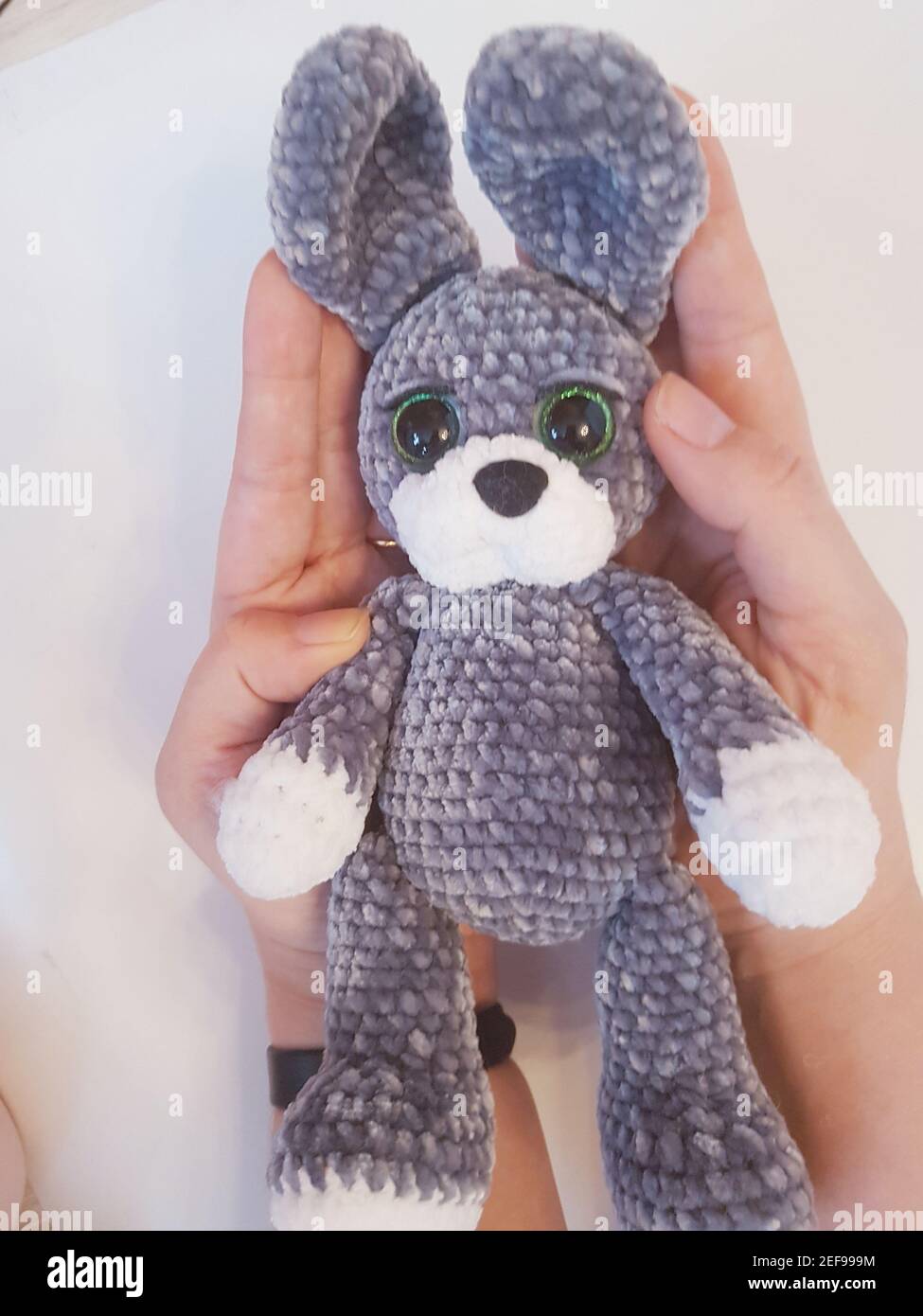 Close-up of a crocheted plush rabbit on a white background Stock Photo