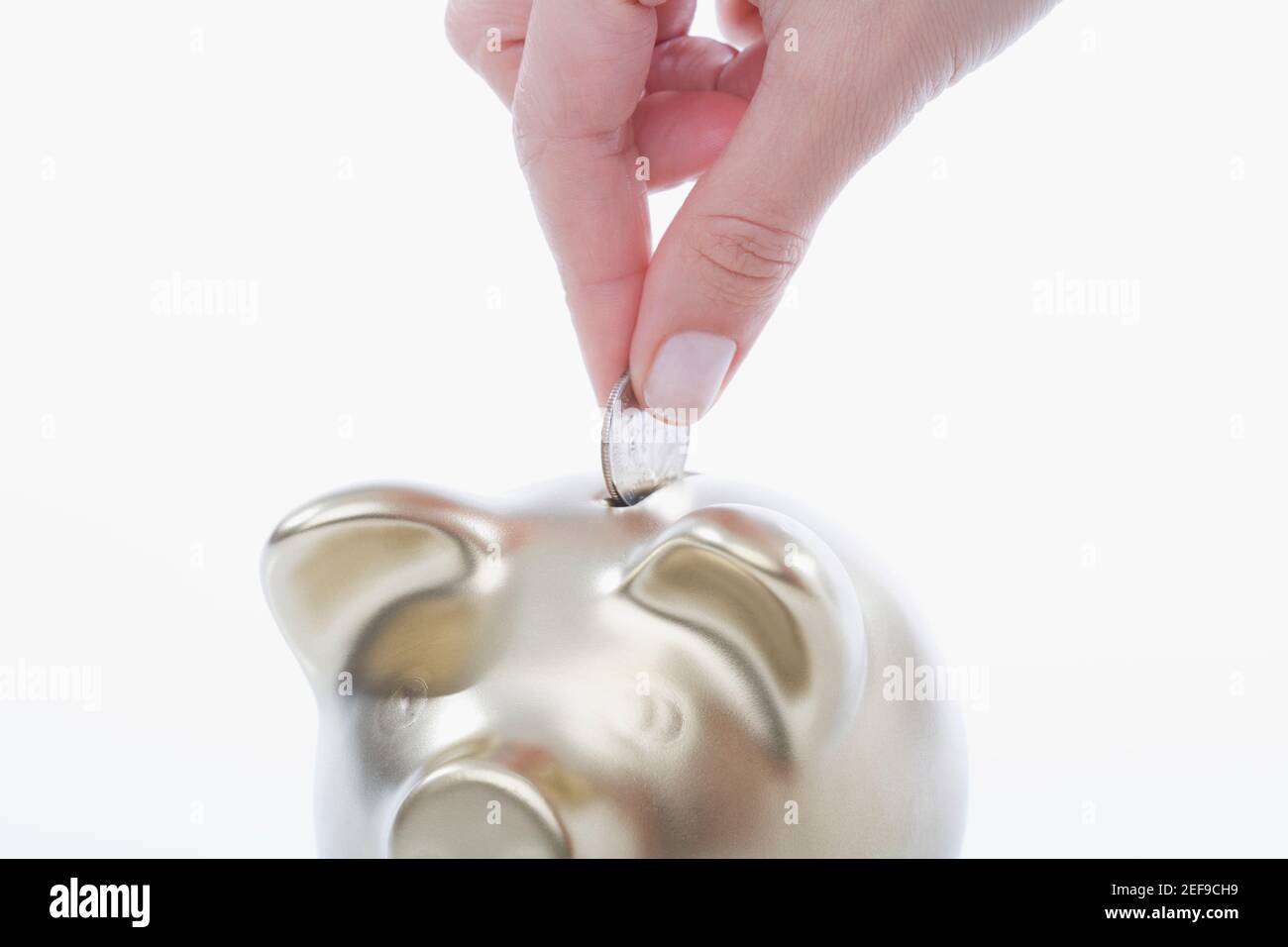 Putting a coin into a piggy bank hi-res stock photography and images ...