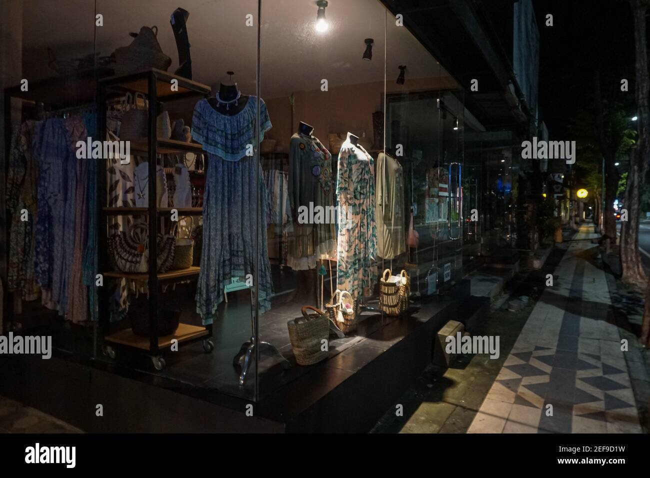 Bali. 16th Feb, 2021. Photo taken on Feb. 16, 2021 shows a store after 9:00 p.m. local time during transitional large-scale social distancing restriction at Seminyak tourism shopping area in Bali, Indonesia. Credit: Bisinglasi/Xinhua/Alamy Live News Stock Photo