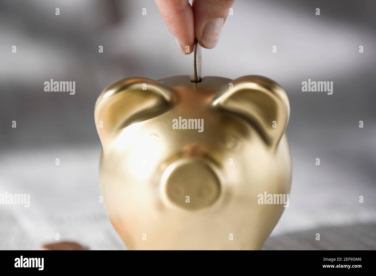 Putting a coin into a piggy bank hi-res stock photography and images ...