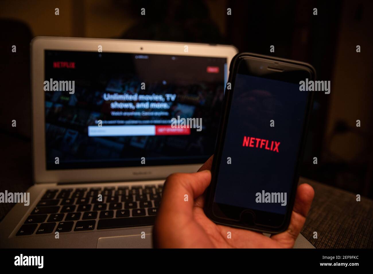 Netflix logo on the screen of a smartphone and a laptop, Netflix is an American subscription streaming service and production company. Stock Photo