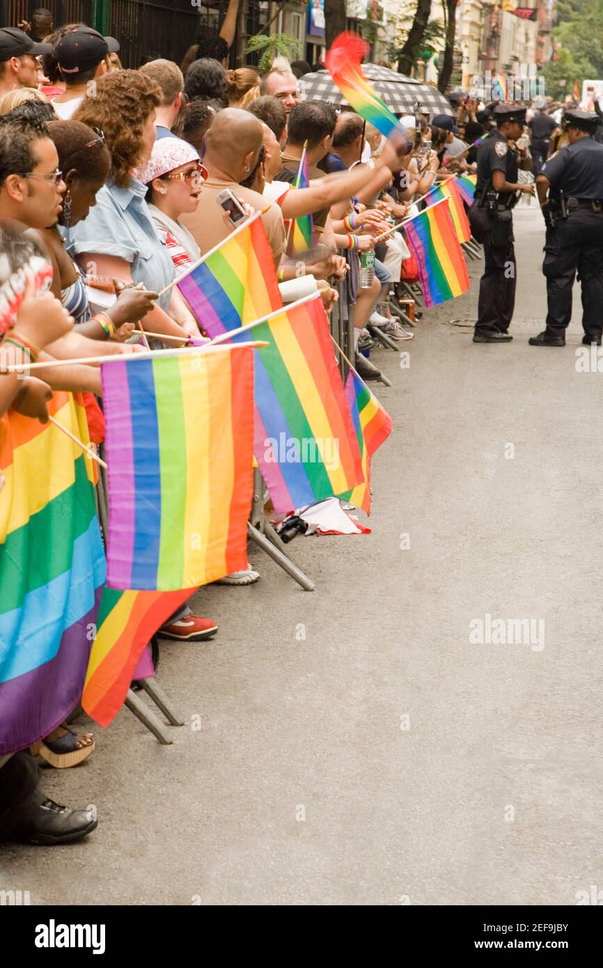 Large group of people holding gay pride flags at a gay parade Stock Photo