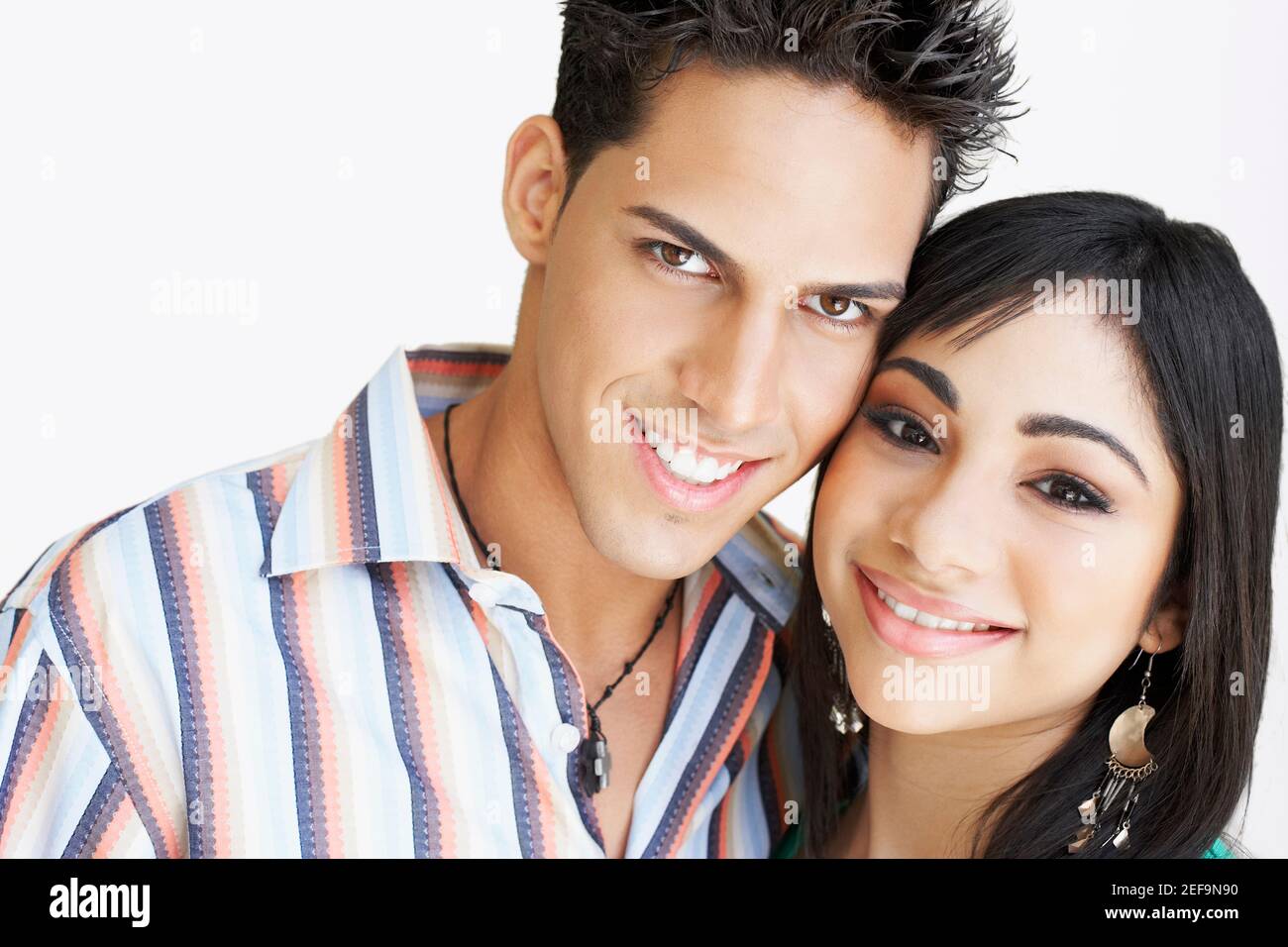 Portrait of a young man and a teenage girl smiling Stock Photo