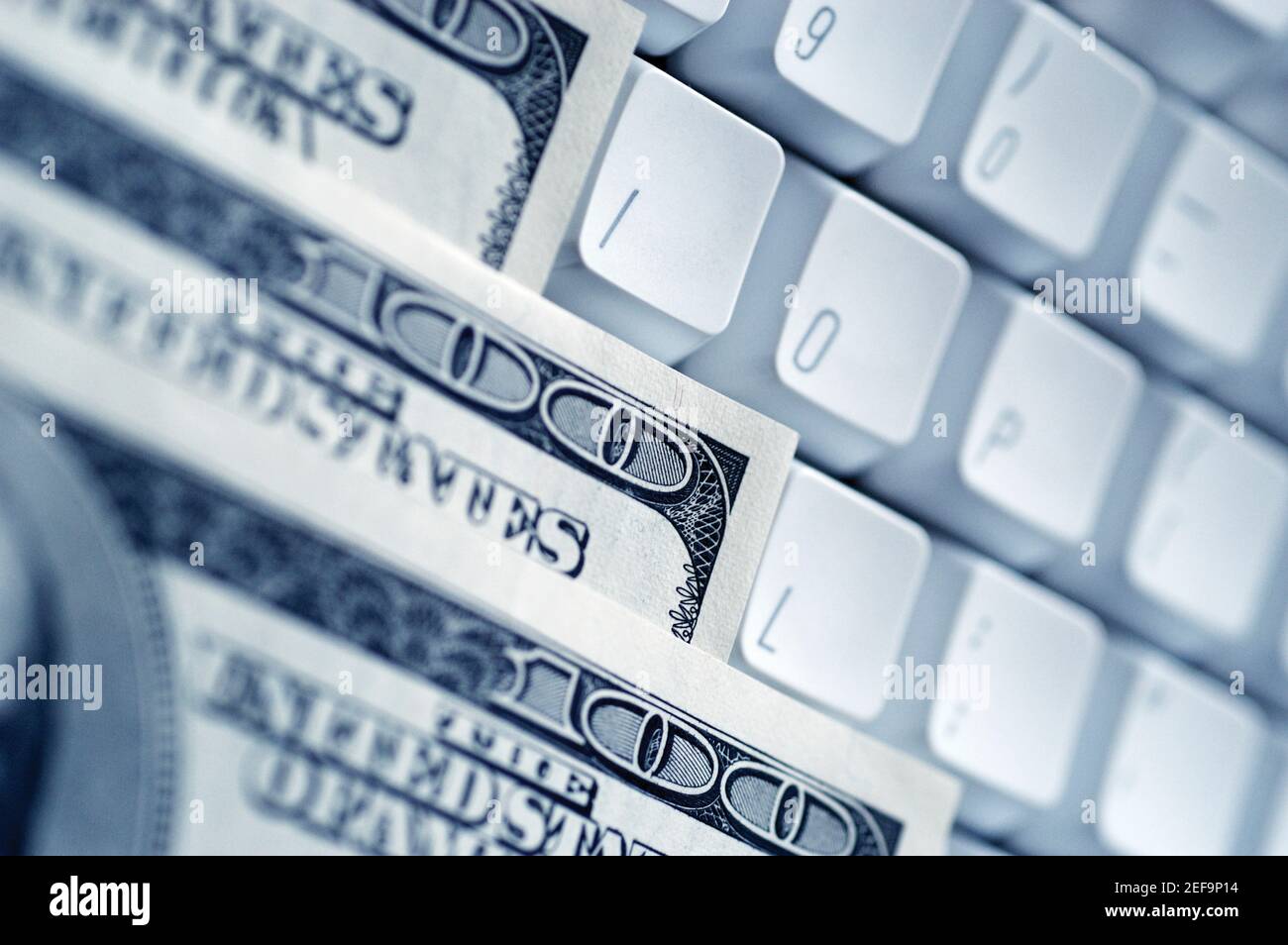 United States one hundred dollar bills on top of computer keyboard ...
