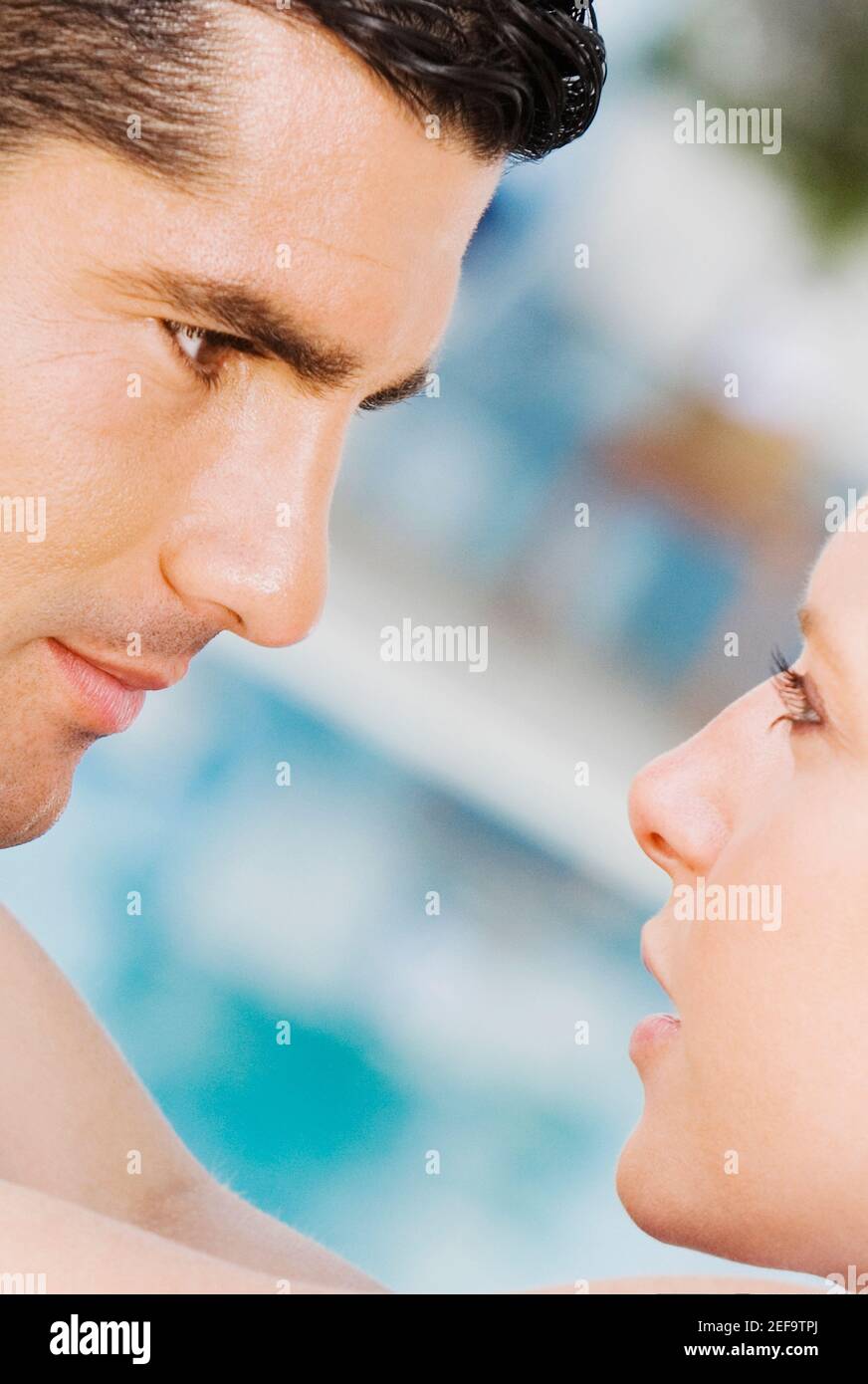 Close-up of a mid adult man looking at a mid adult woman Stock Photo