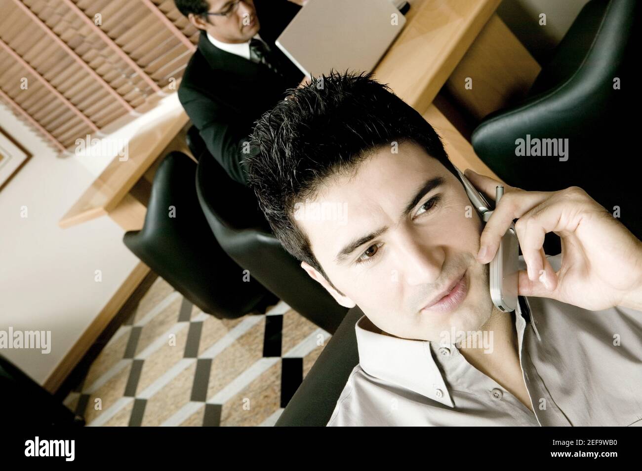 Two young businessmen working in an office Stock Photo