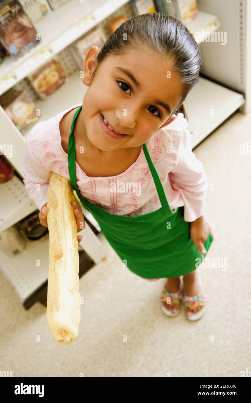 Portrait of a girl holding a baguette and smiling Stock Photo Alamy