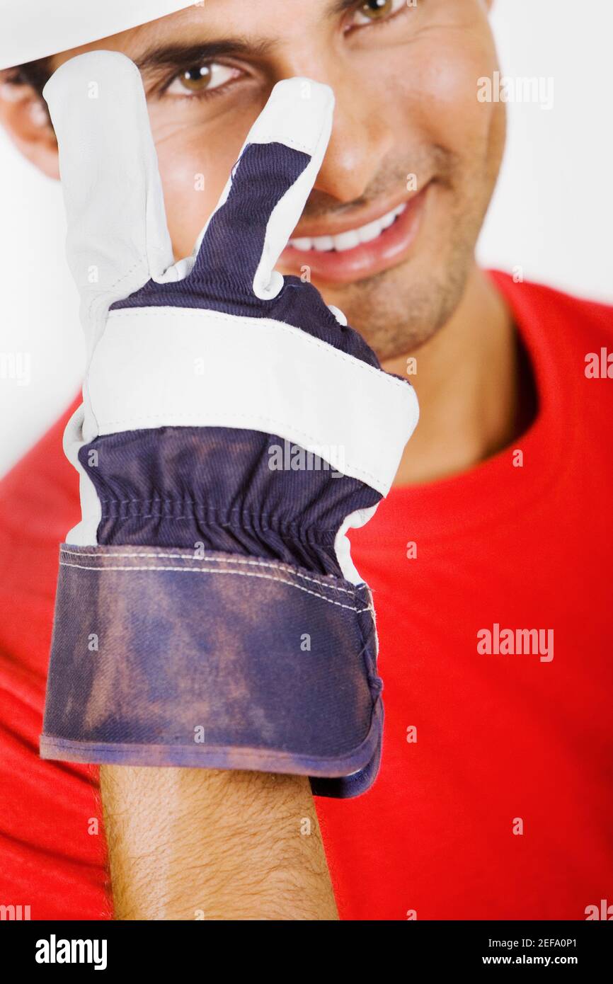 Portrait of a young man showing a peace sign Stock Photo - Alamy