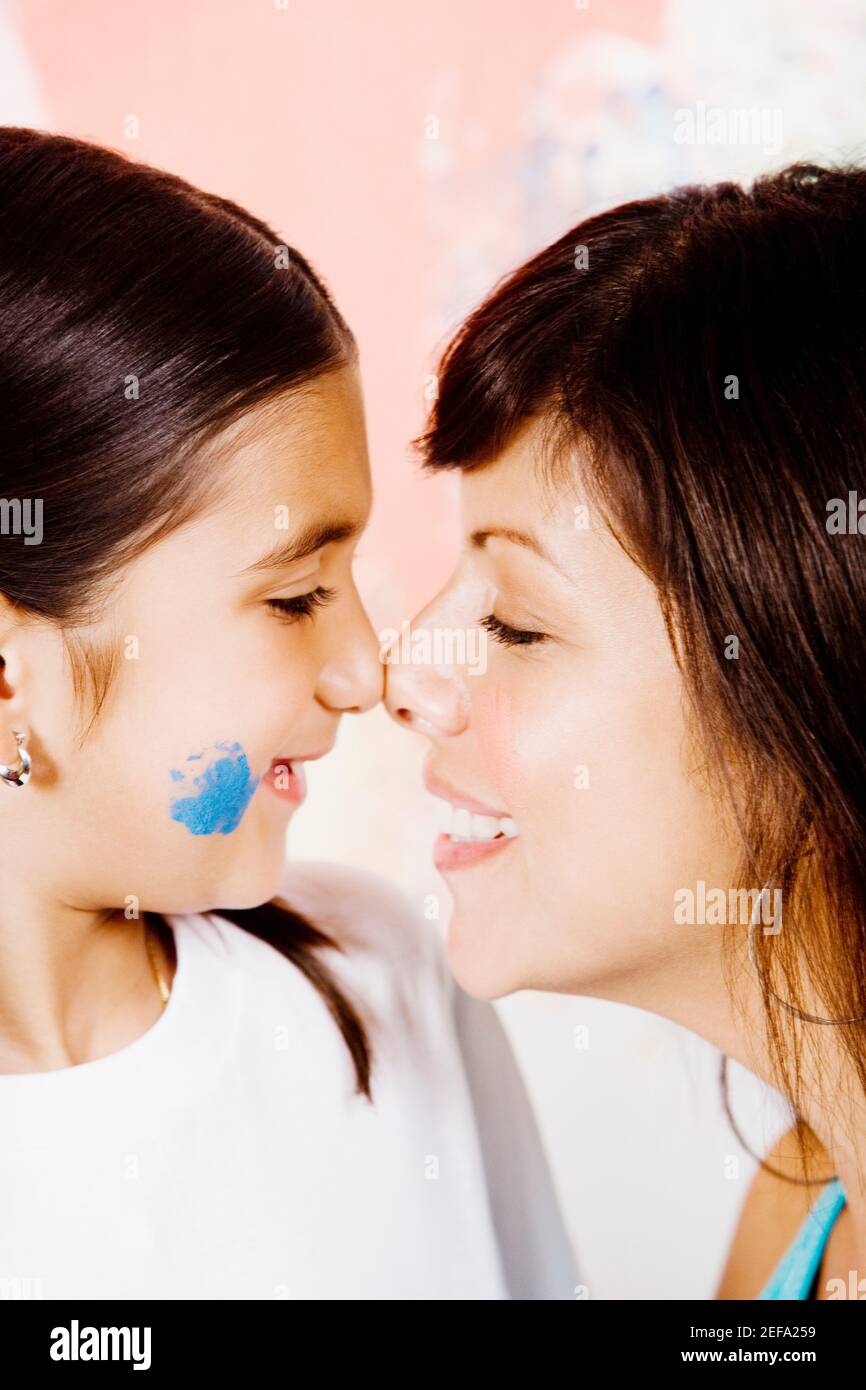 Closeup of a young woman and her daughter rubbing noses Stock Photo
