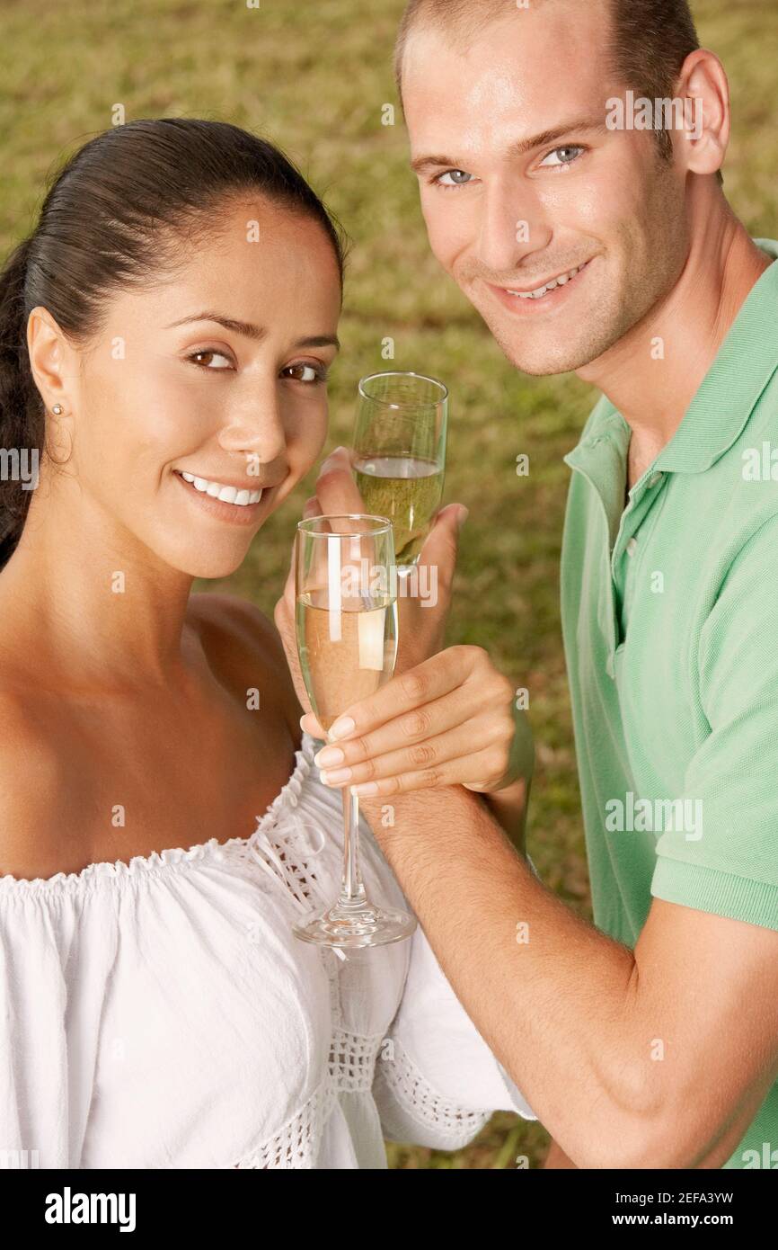 Portrait of a young couple holding champagne flutes Stock Photo