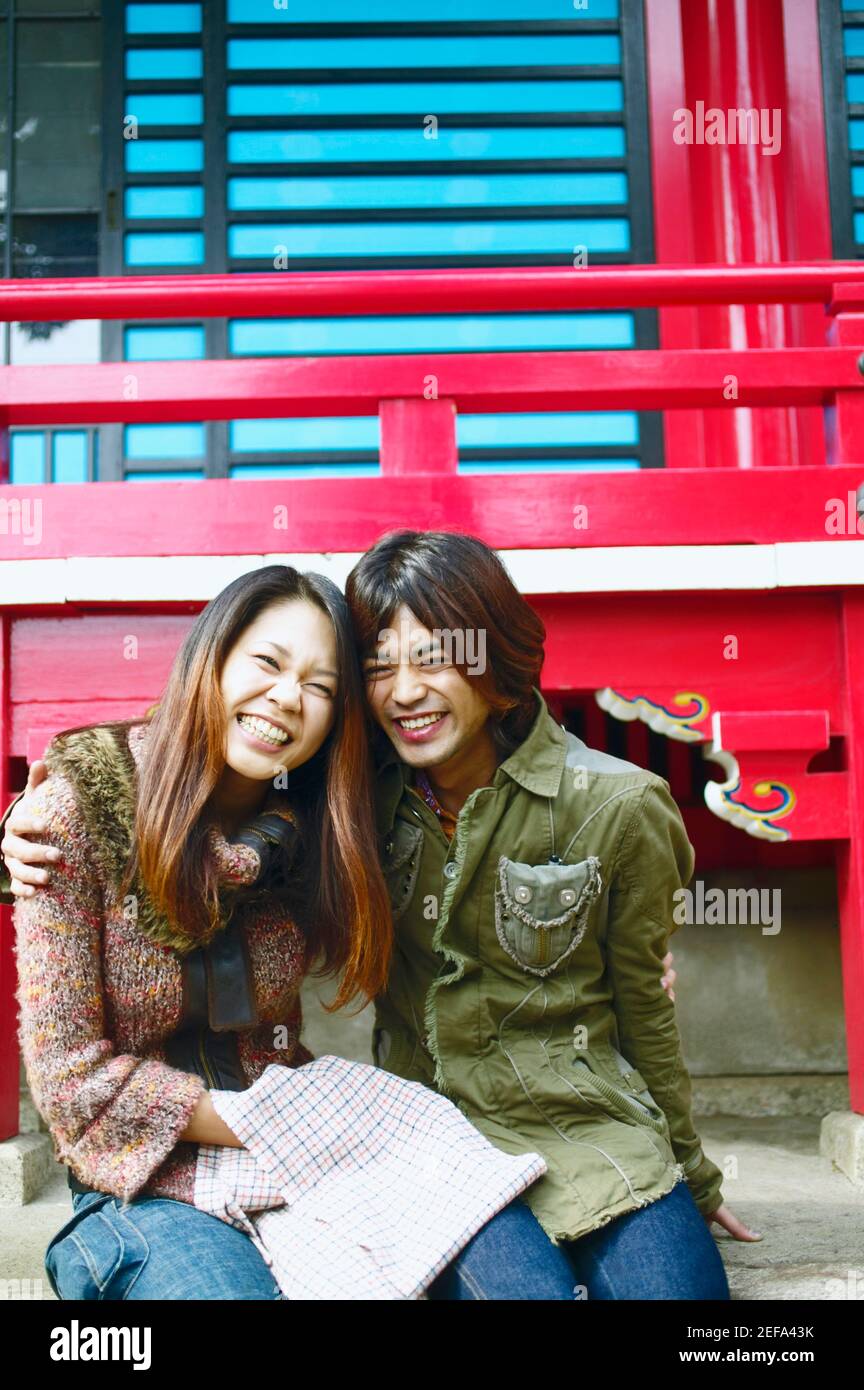 Young woman and a mid adult man sitting together and smiling Stock ...
