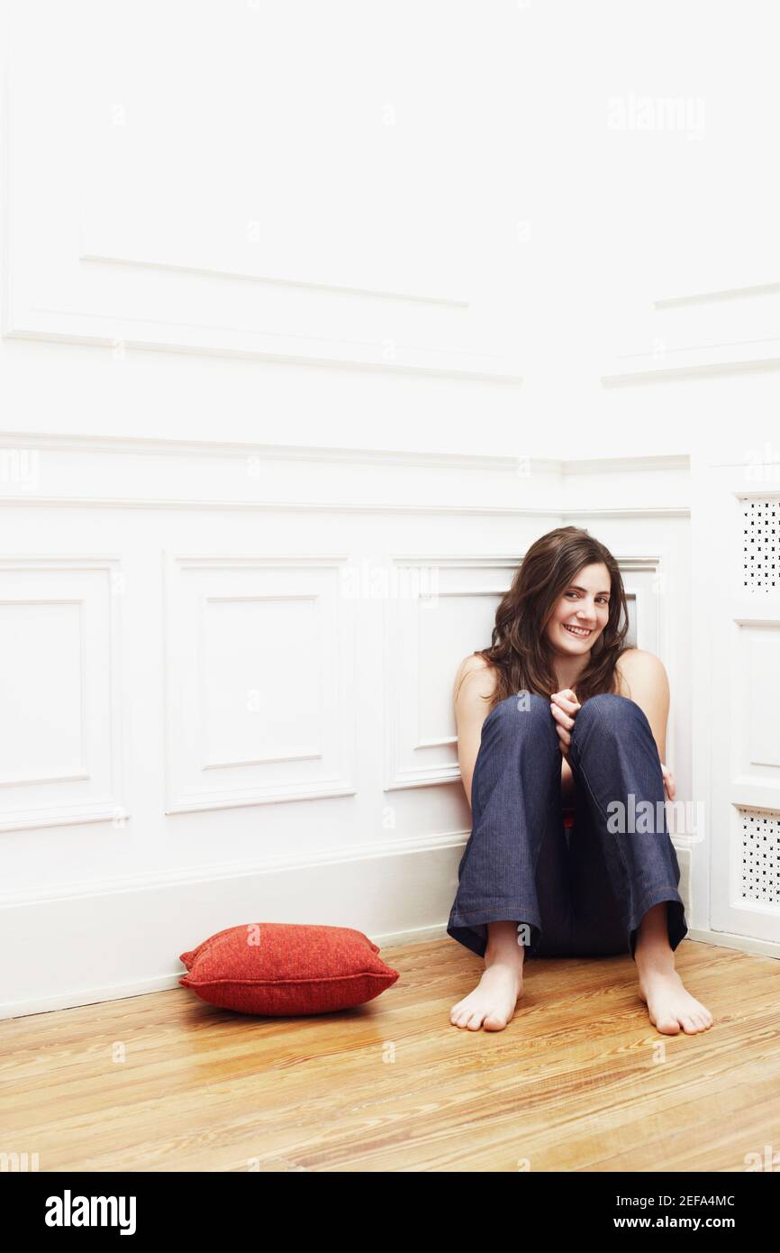 One woman sitting on cushion floor hires stock photography and images