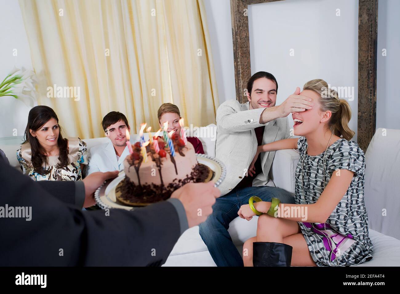 Young woman celebrating a birthday party with her friends Stock Photo