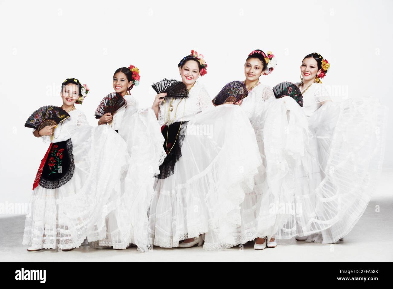 Portrait of a group of female dancers holding folding fans Stock Photo