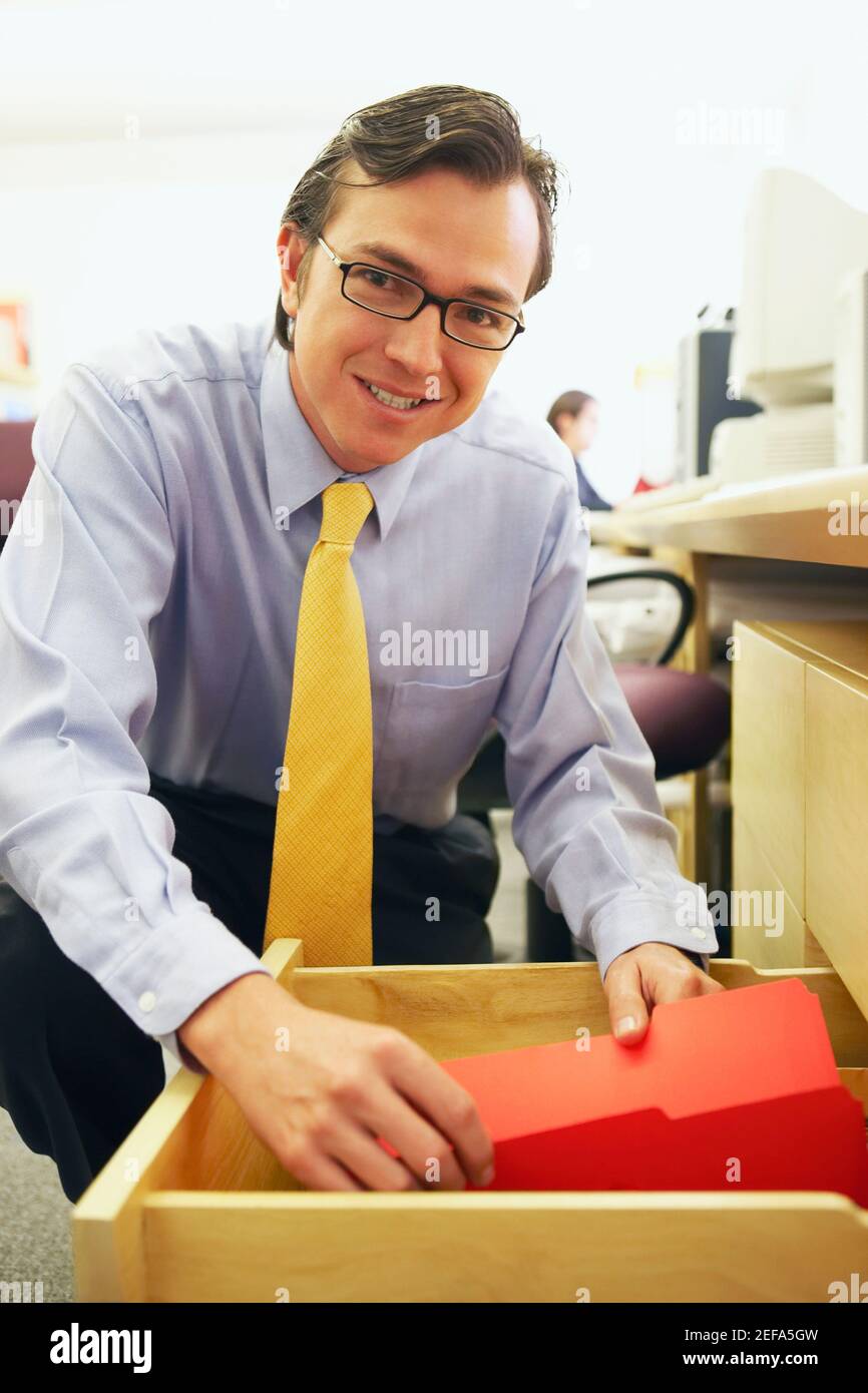 Portrait of a businessman holding a file in a drawer Stock Photo