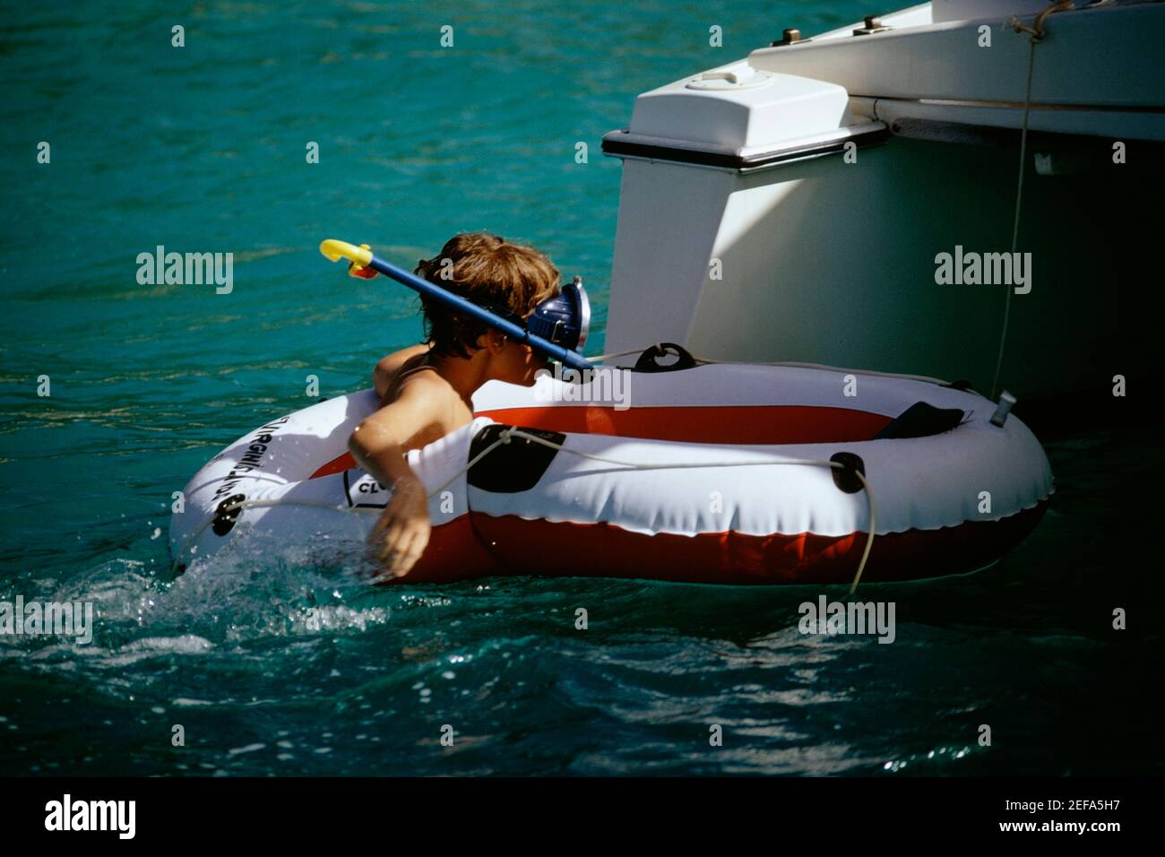 Boy wearing a scuba floating on a lifesaving ring Stock Photo - Alamy