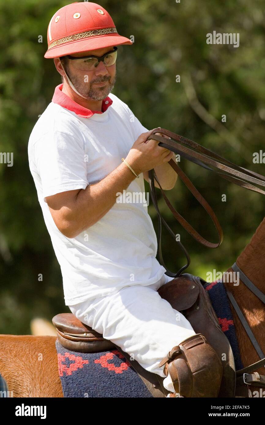 Mature man riding a horse Stock Photo - Alamy