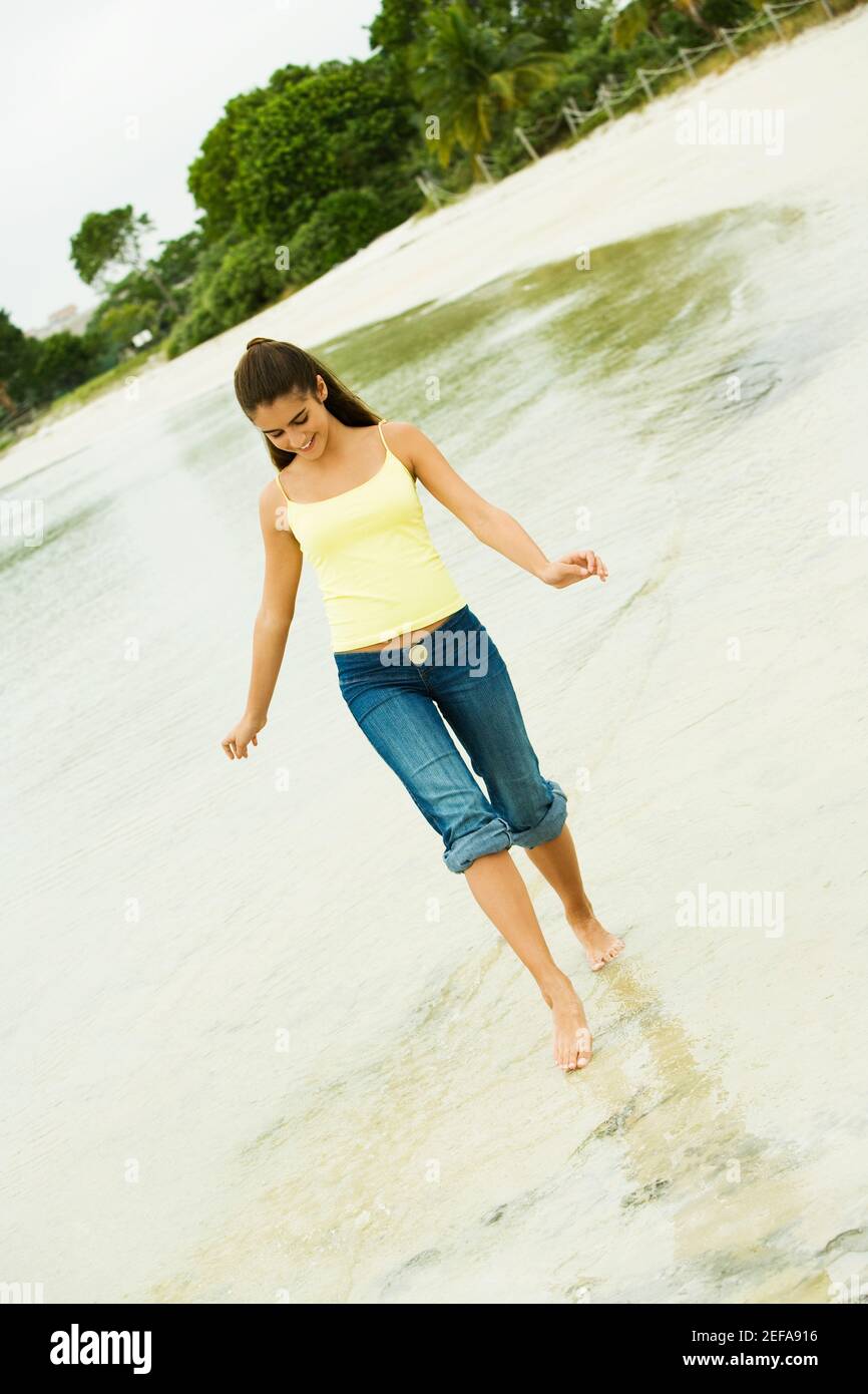 Girl wading in water on the beach Stock Photo Alamy