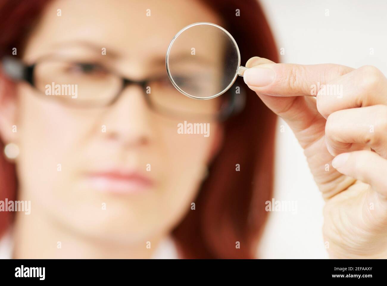 Close-up of a female optometrist holding a lens Stock Photo