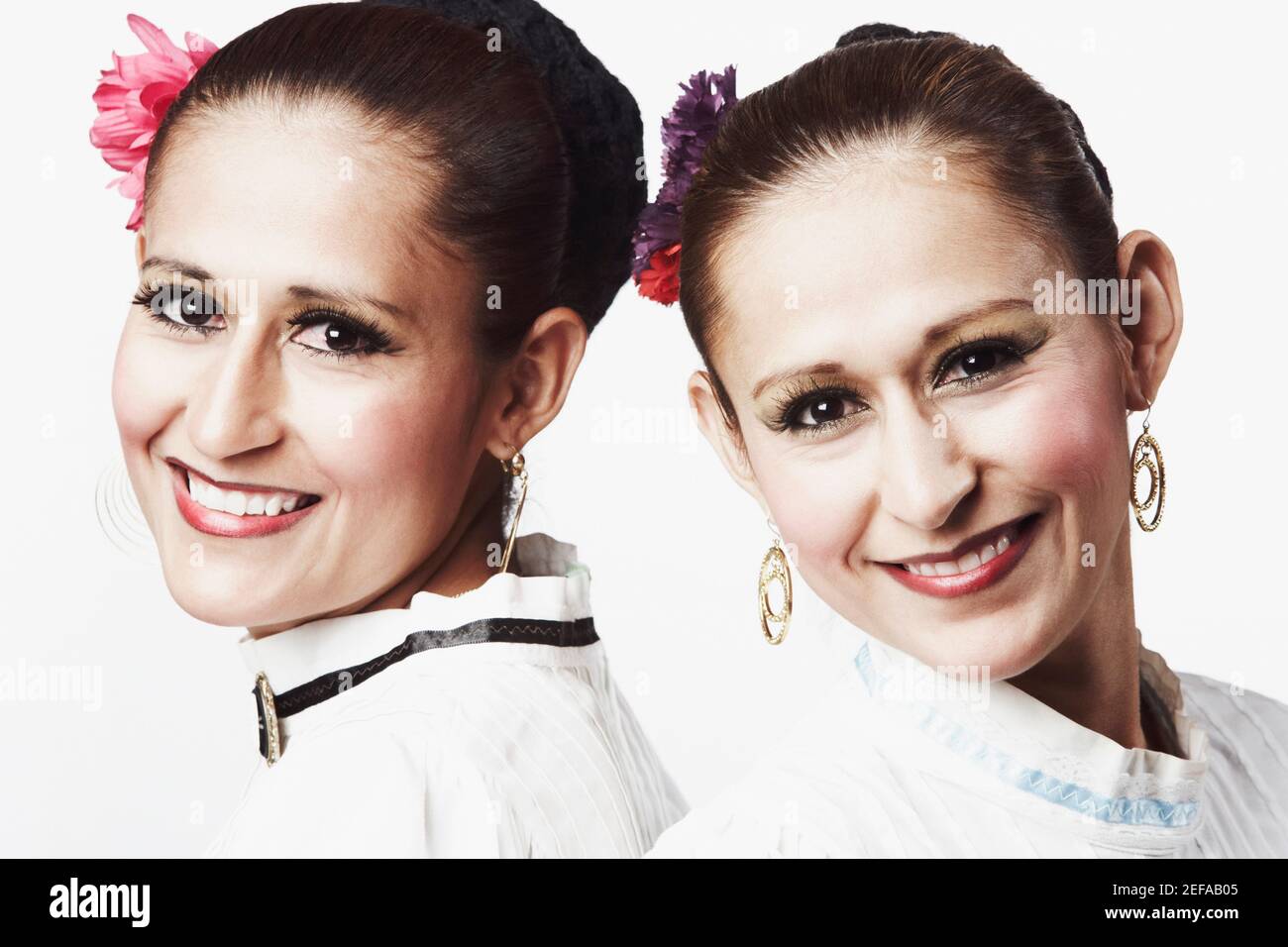 Portrait of two young women posing and smiling Stock Photo - Alamy