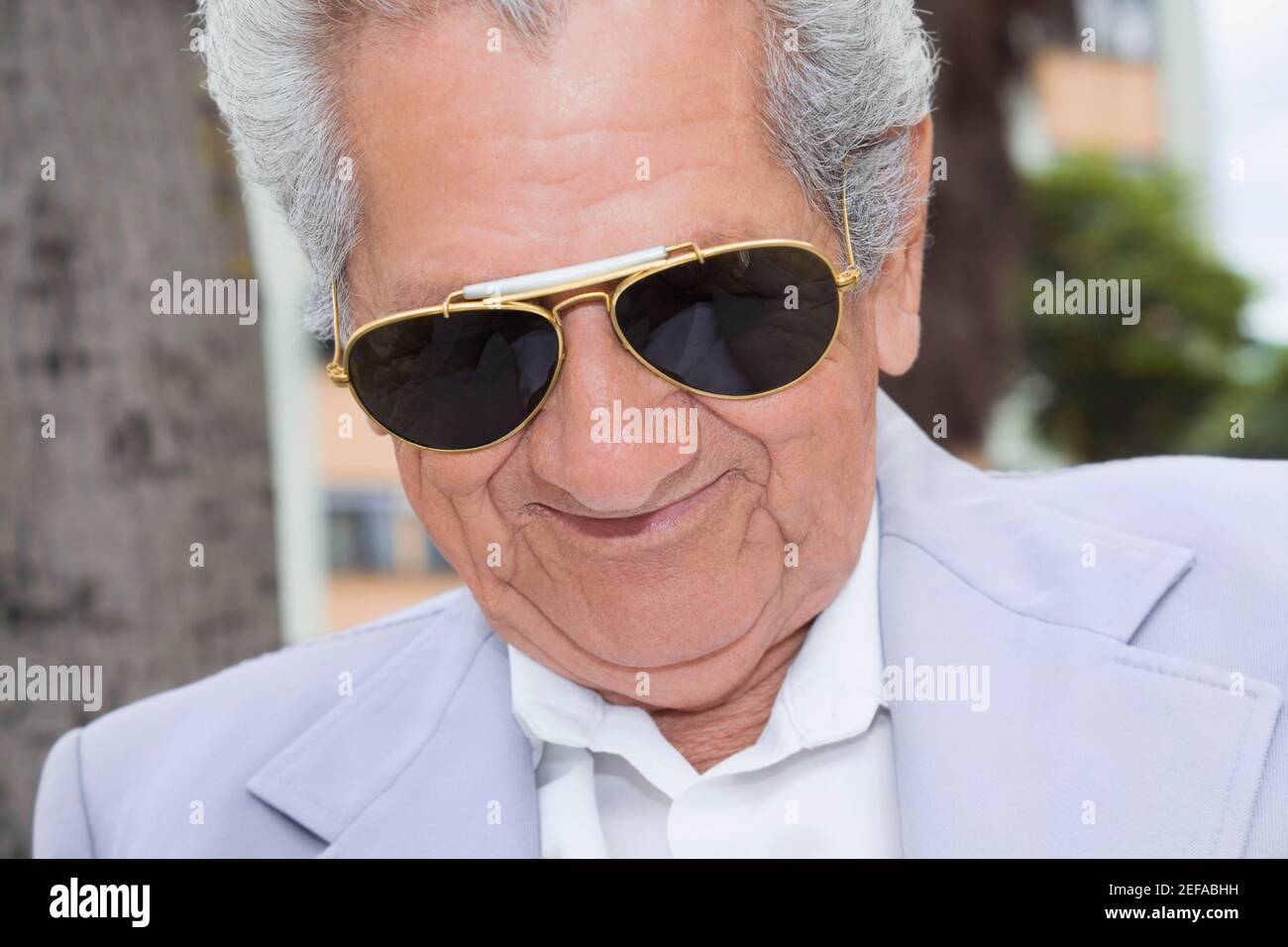 Close-up of a senior man wearing sunglasses and smiling Stock Photo