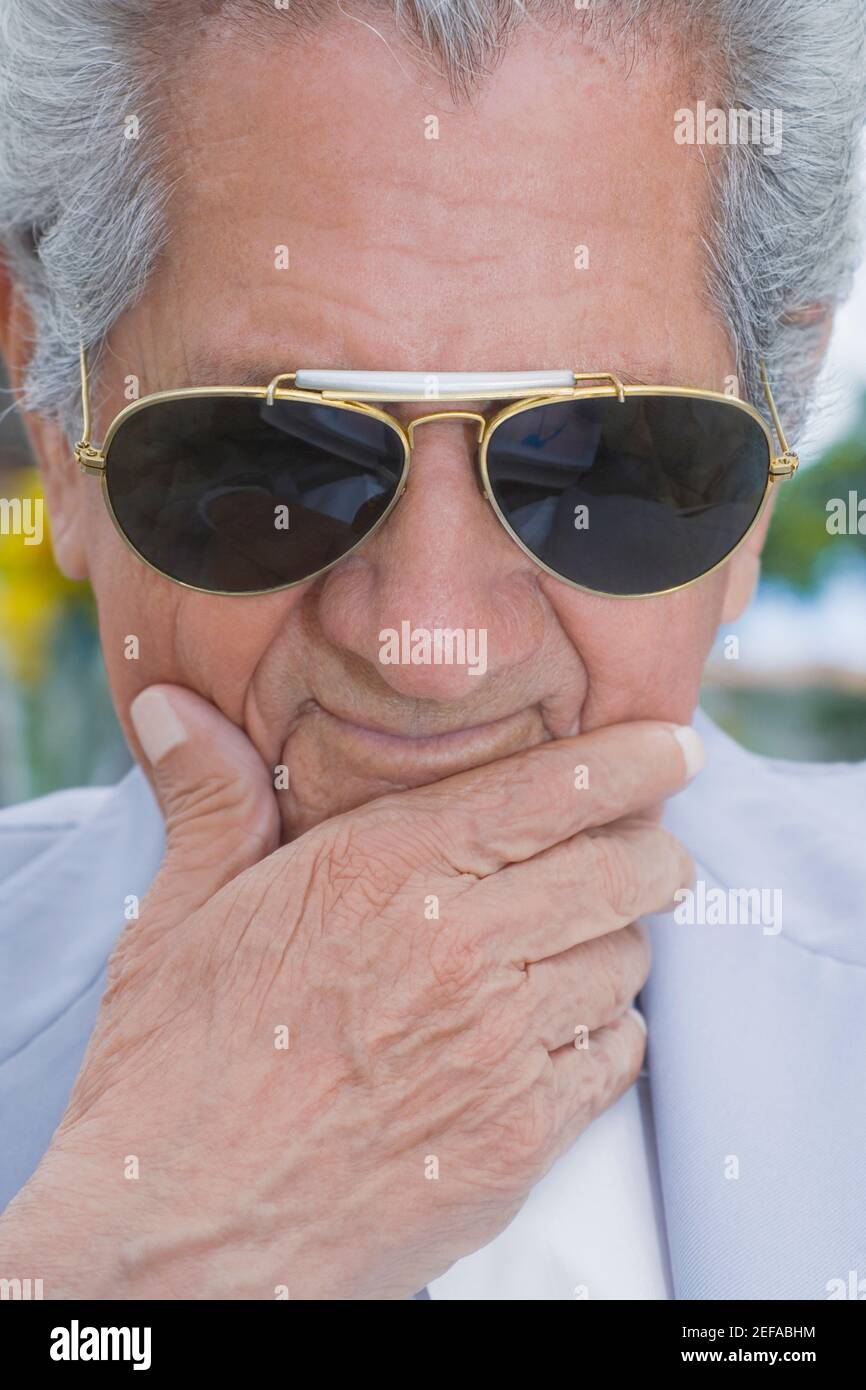 Close-up of a senior man wearing sunglasses and thinking Stock Photo