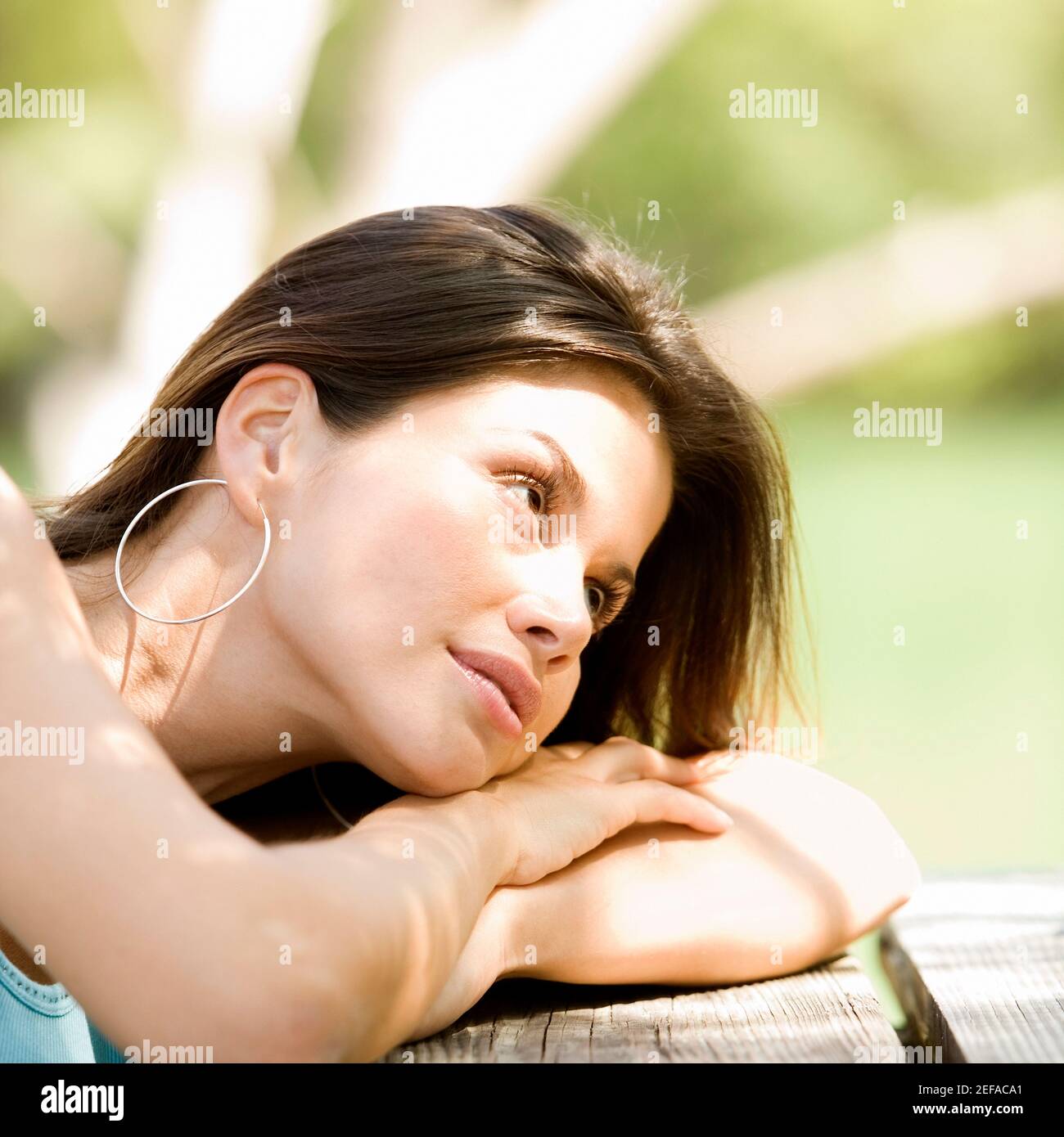 Close-up of a young woman resting on a bench Stock Photo
