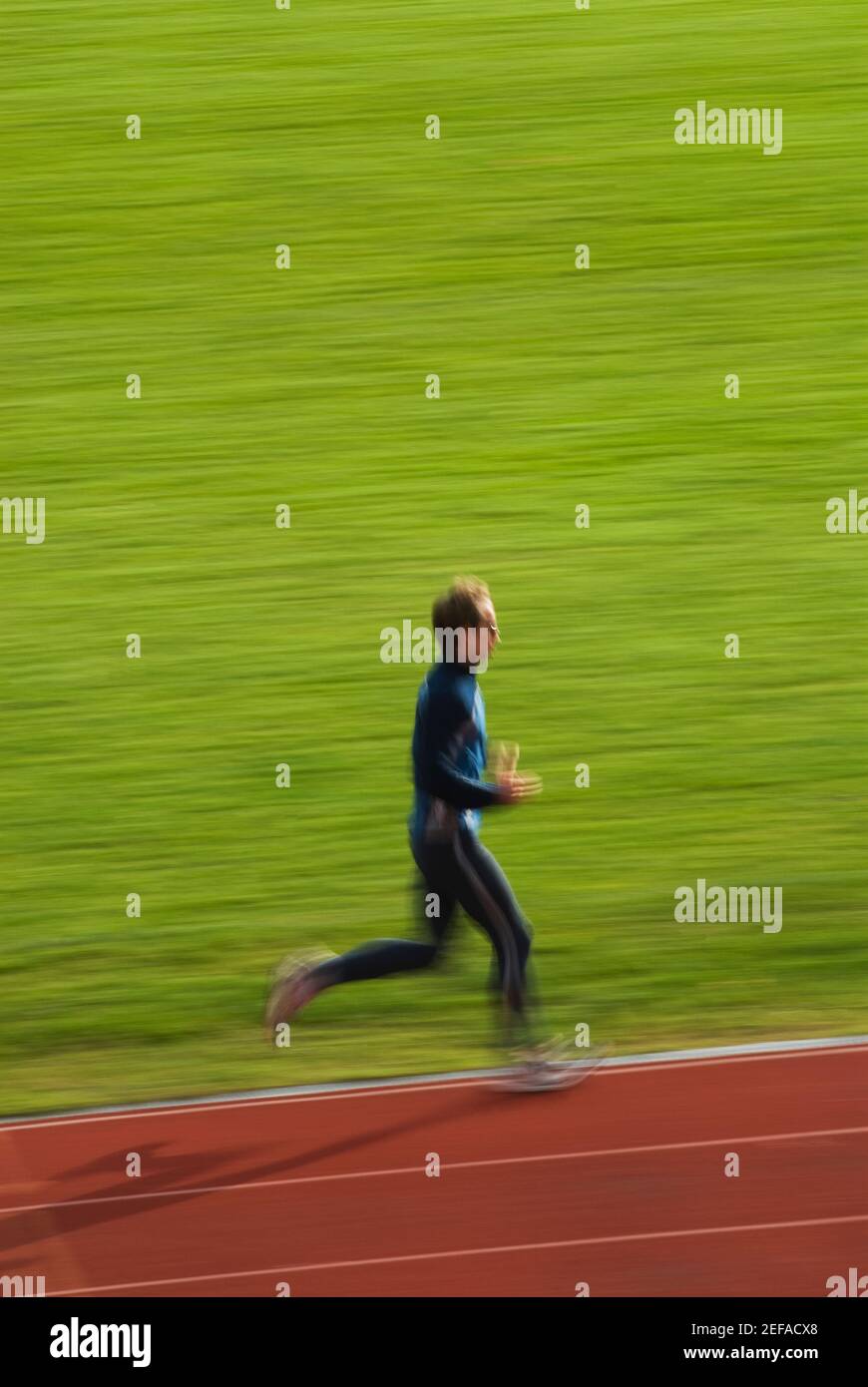 Pro Running Side Side profile of a mid adult man running on a running track Stock Photo ...