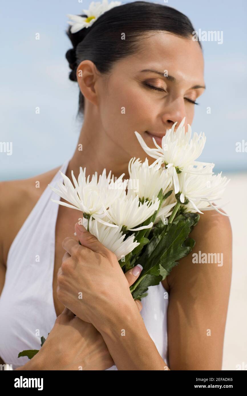 Close-up of a young woman smelling a flower Stock Photo - Alamy