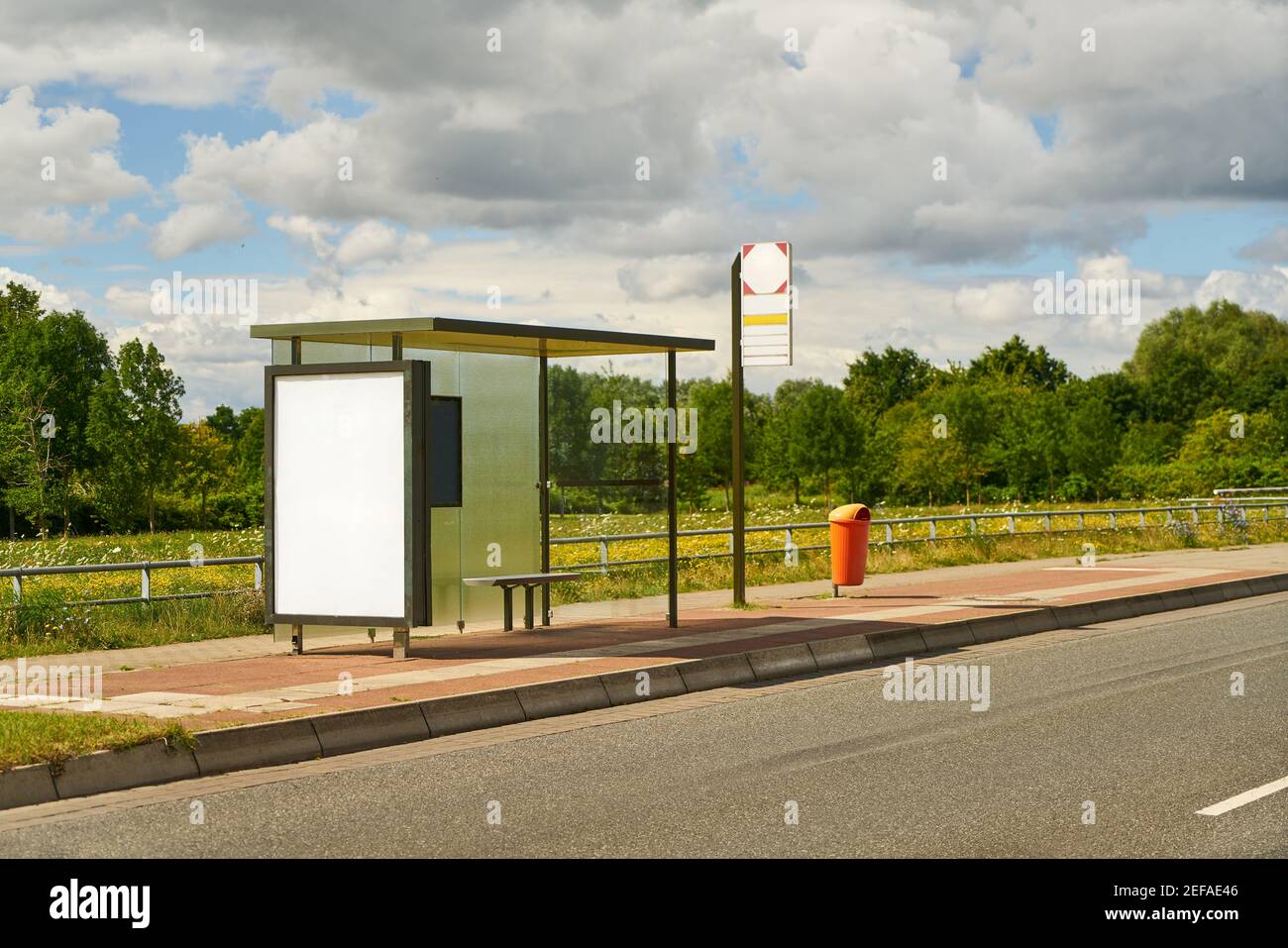 Empty advertising space as mock-up at bus stop on summer day Stock Photo