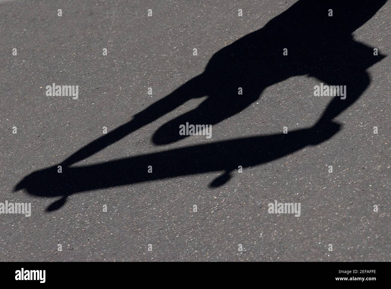 High angle view of shadow of a person holding a skateboard Stock Photo