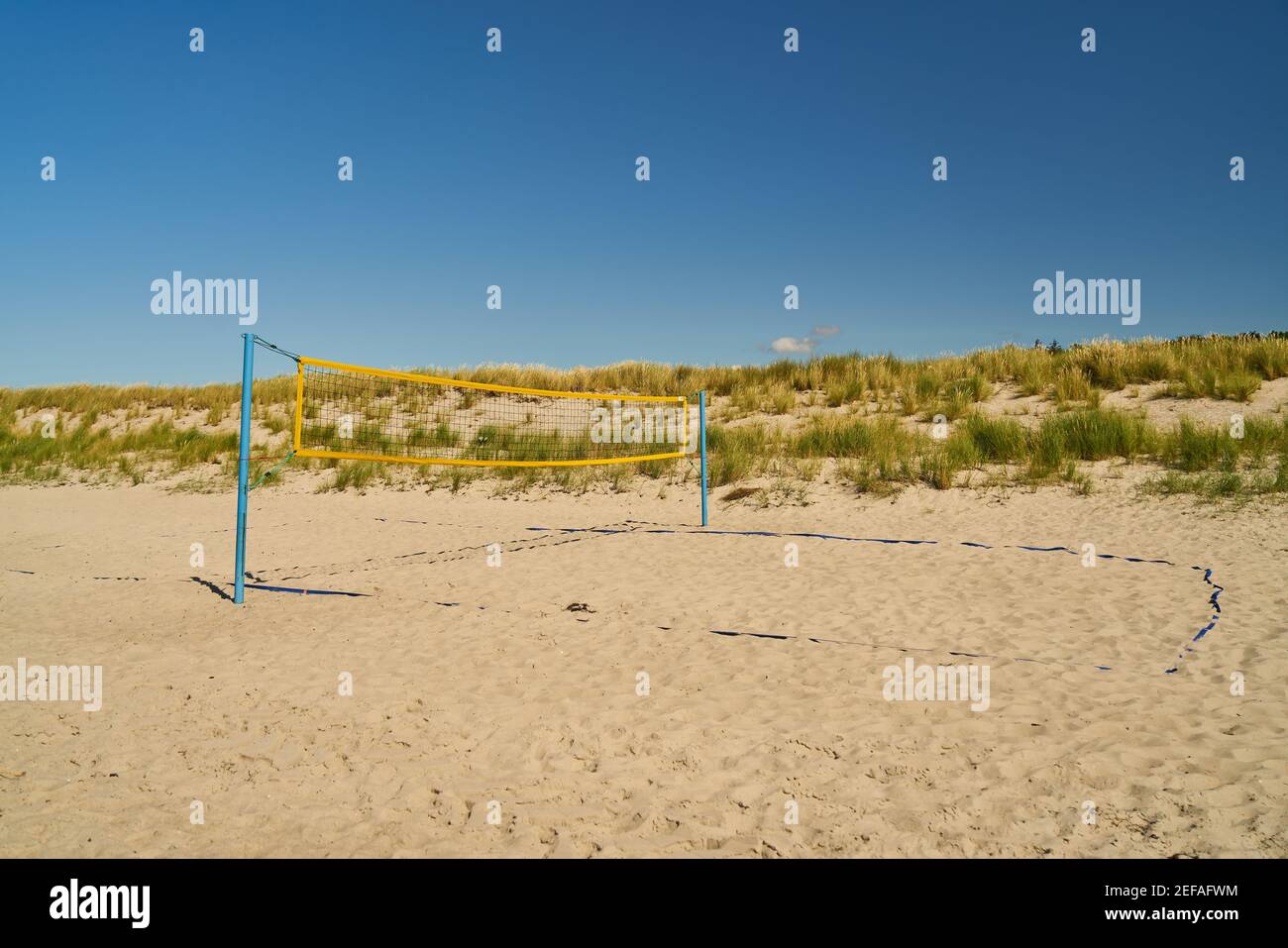 Playing field for volleyball with net on the beach against a blue sky in summer Stock Photo