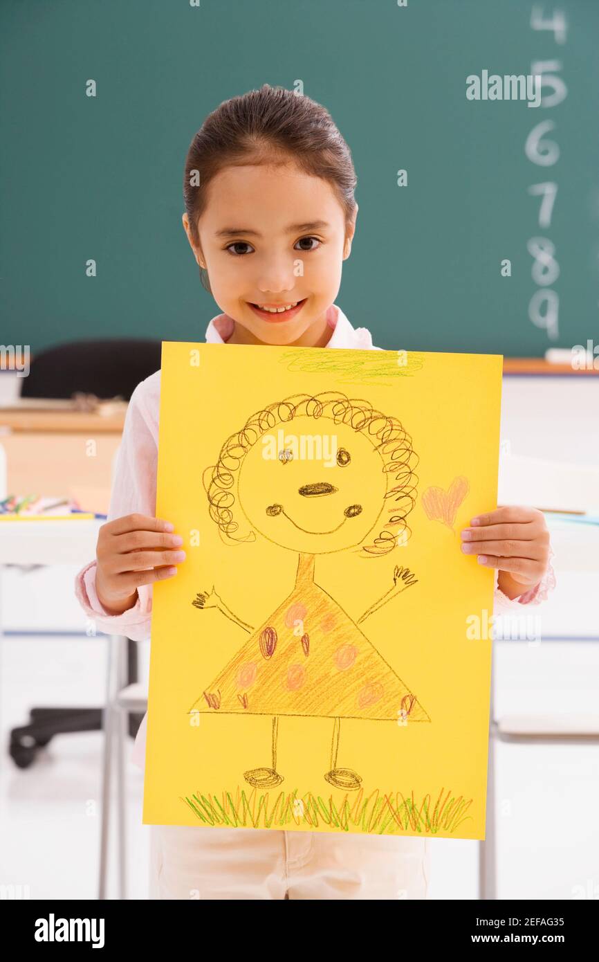 Portrait of a schoolgirl showing her drawing and smiling Stock Photo ...