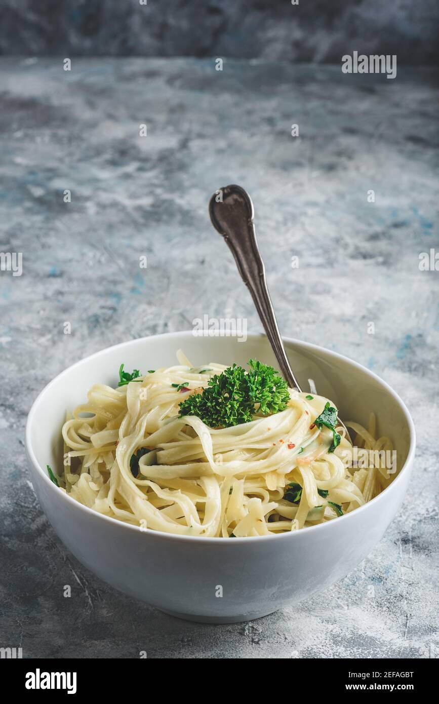Easy lunch recipe. Linguine pasta with olive oil, garlic, fresh parsley and grated parmesan