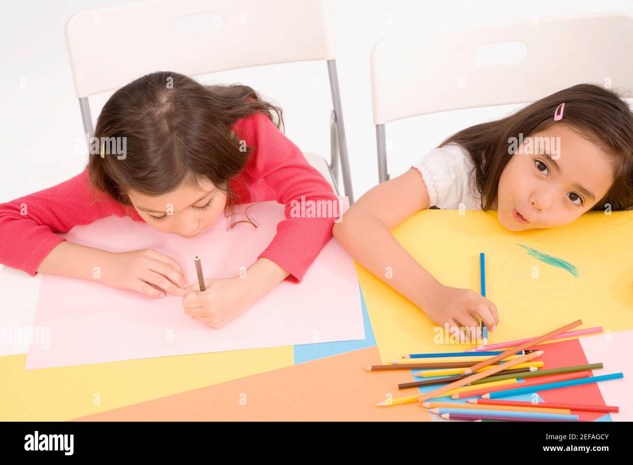 High angle view of two schoolgirls drawing in an art class Stock Photo
