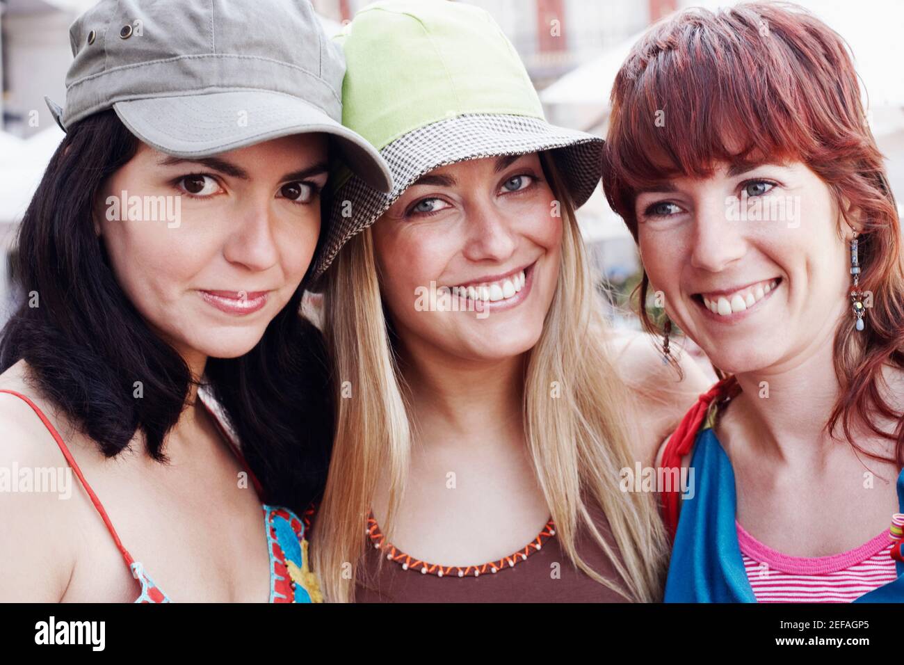 Portrait of two young women and a mid adult woman smiling Stock Photo ...