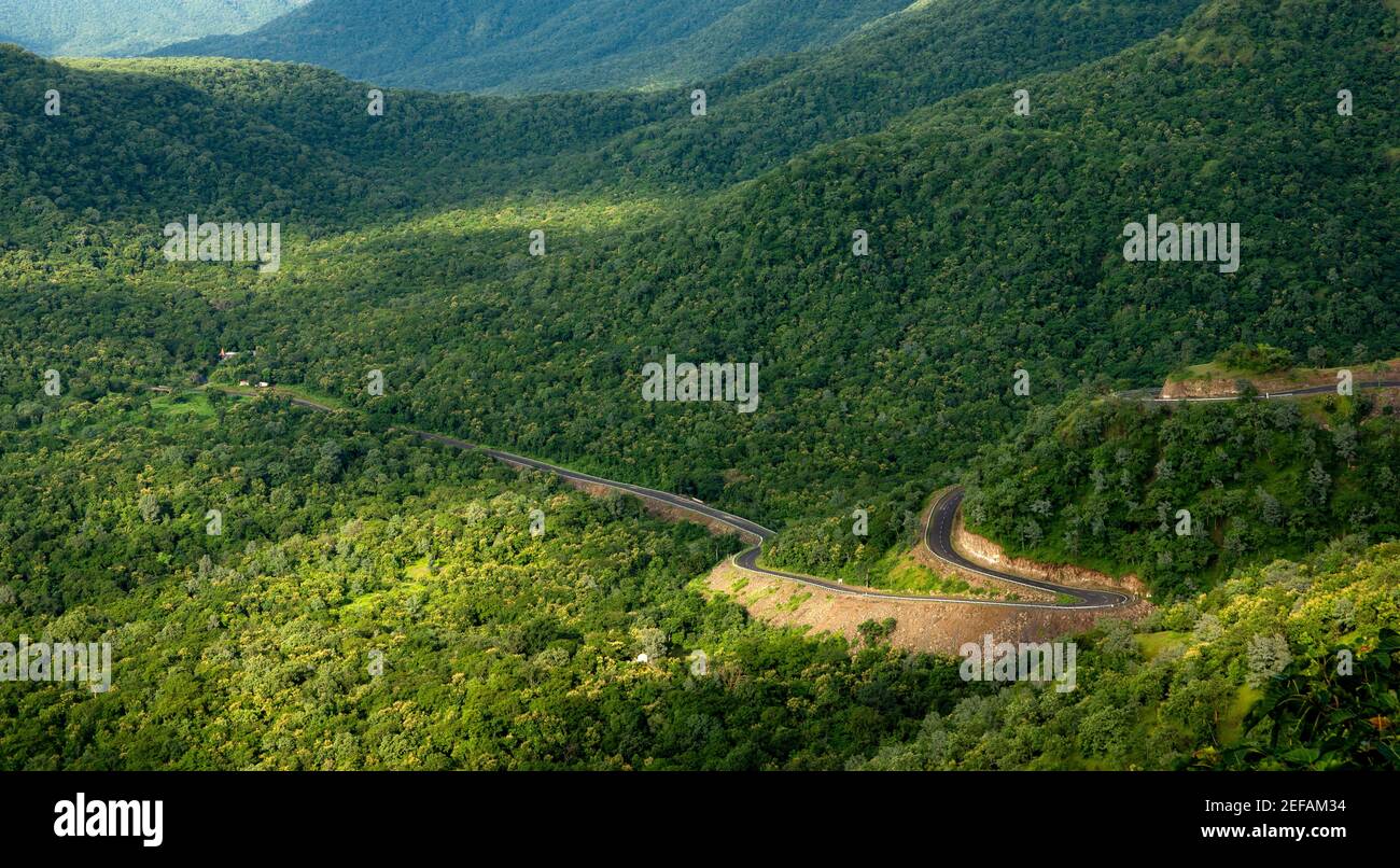 Aerial view of a winding road in the scenic green mountains Stock Photo ...