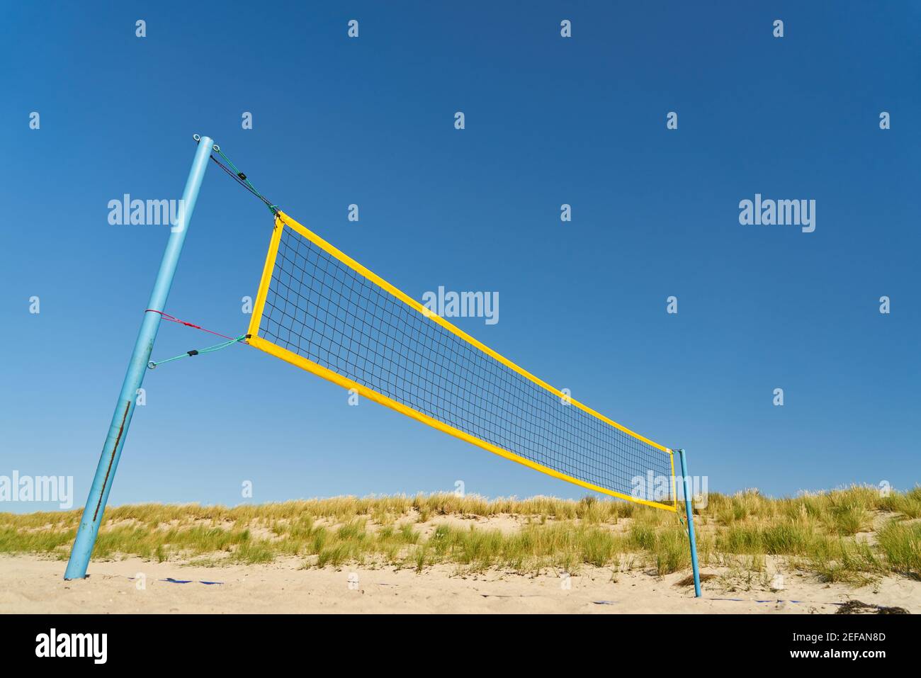 Net on volleyball field on the beach in summer with a blue sky Stock Photo