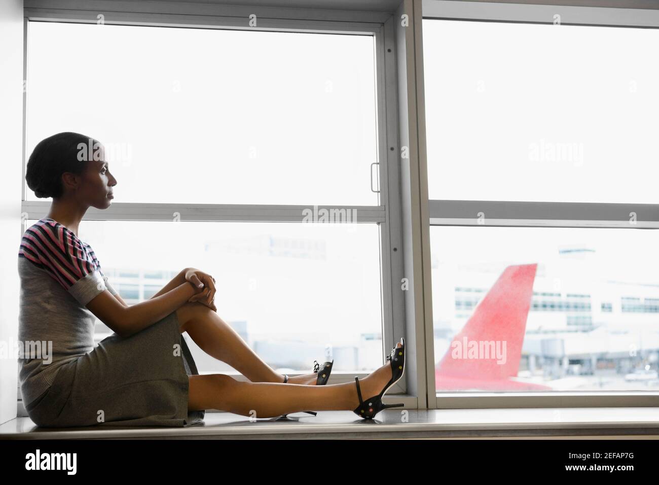 African woman sitting alone side view hi-res stock photography and ...