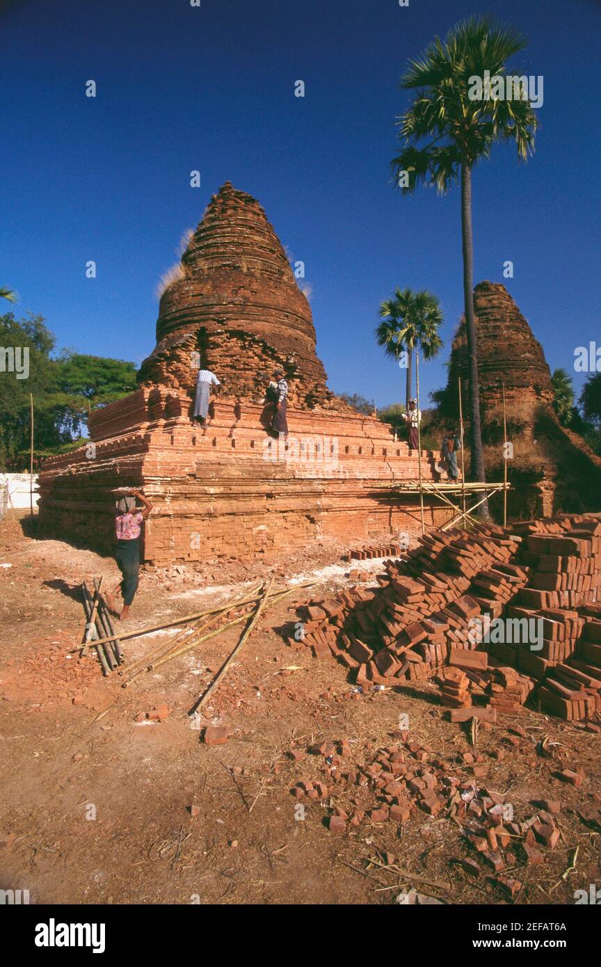 Manual workers repairing a pagoda, Bagan, Myanmar Stock Photo