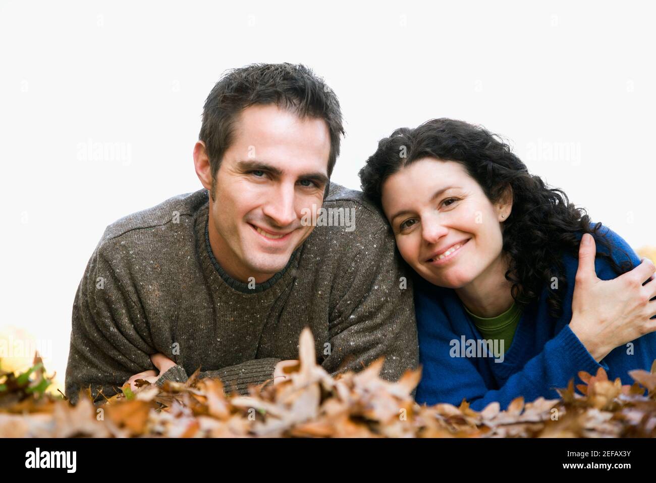 Portrait of a couple lying in a lawn Stock Photo - Alamy