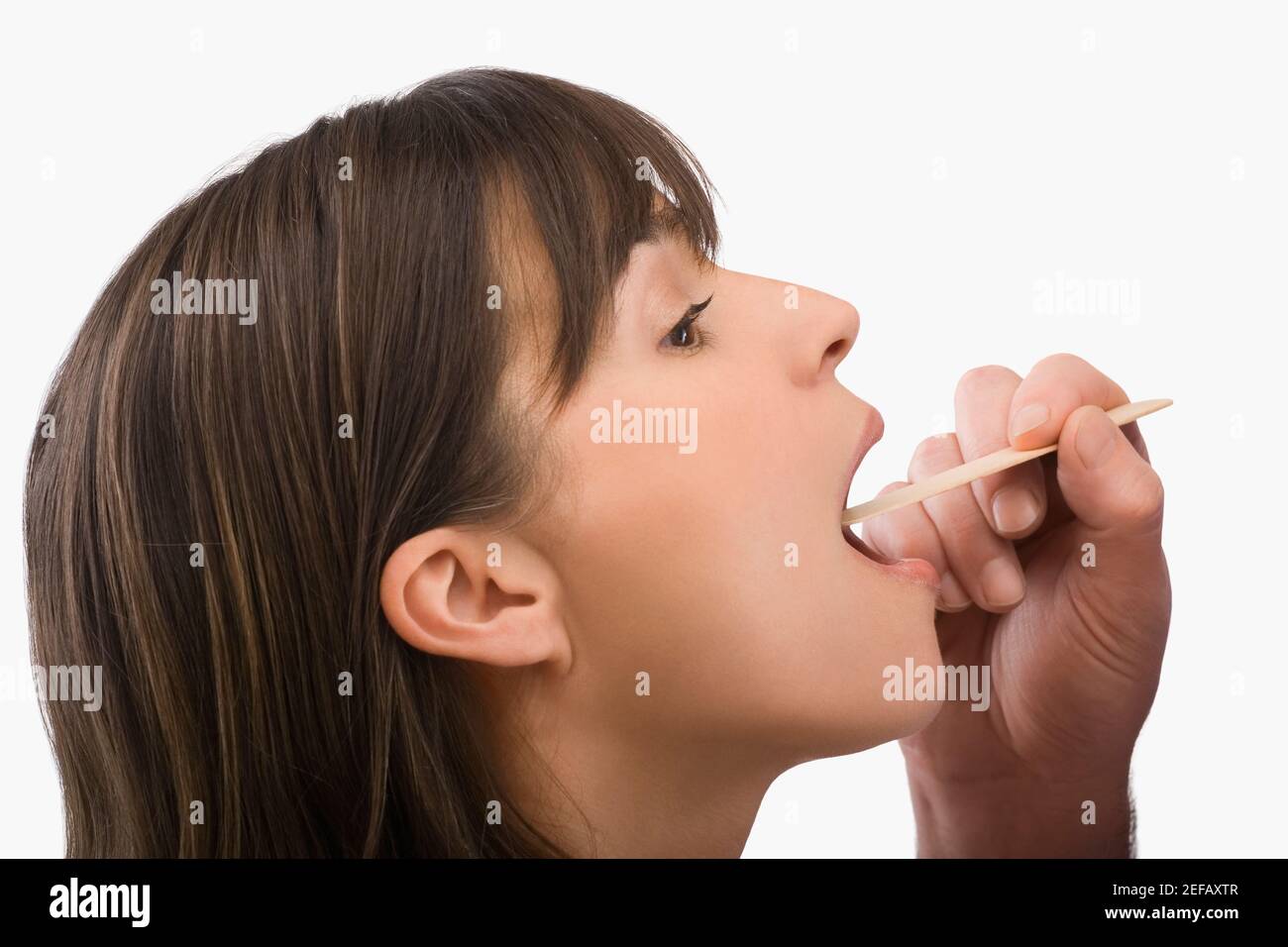 Close_up of a mature woman having a throat examination Stock Photo