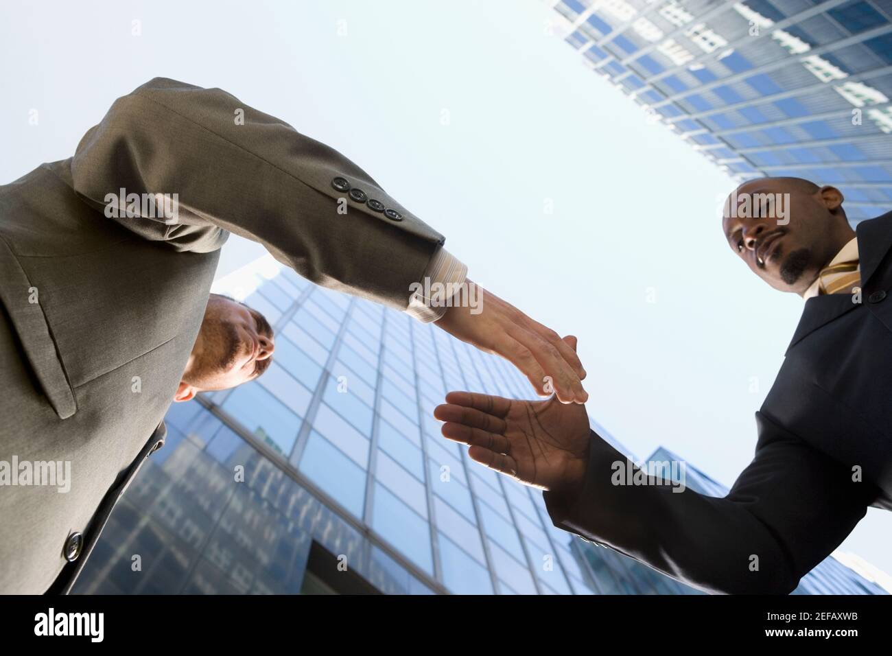 Low angle view of two businessmen shaking hands Stock Photo