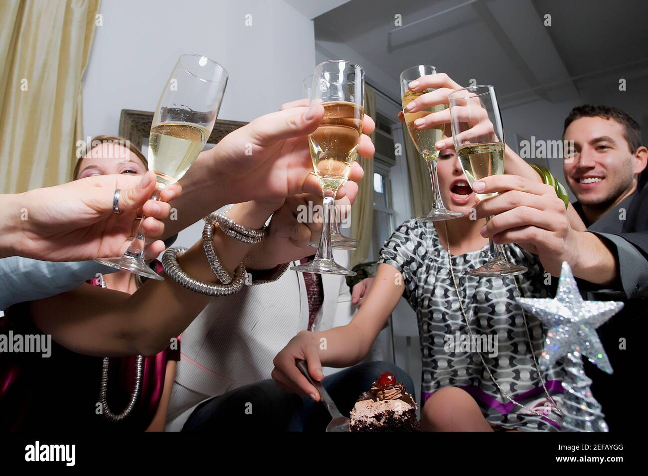 Low angle view of a young woman celebrating birthday with her friends Stock Photo