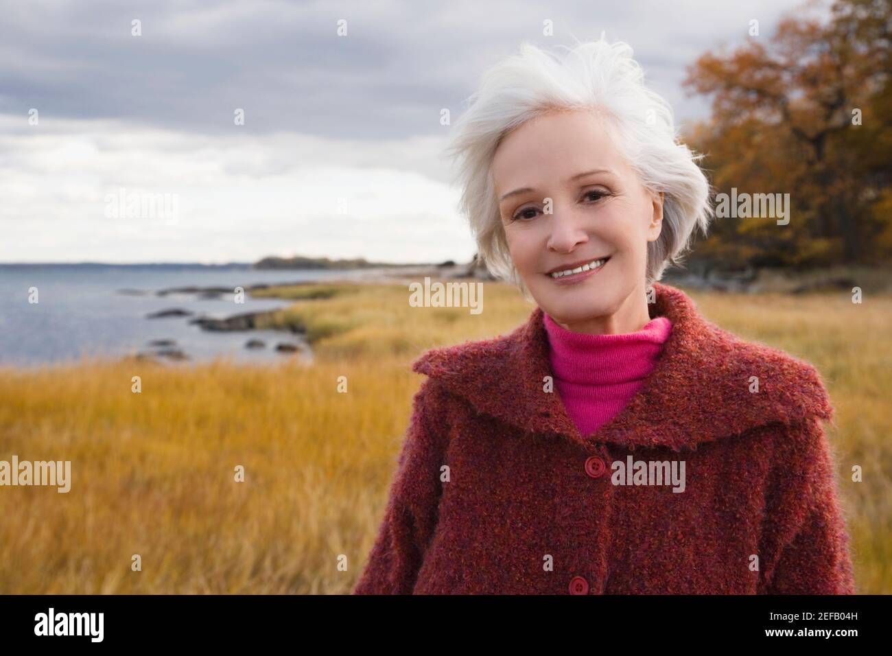 Portrait of a senior woman smiling on the beach Stock Photo - Alamy