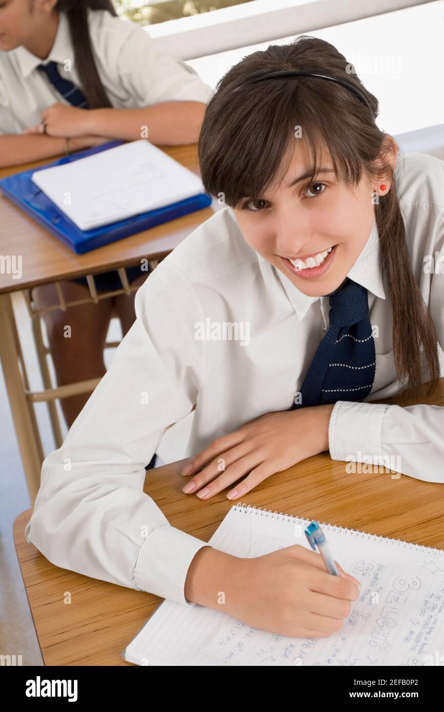 Portrait of a teenage girl smiling in a classroom Stock Photo - Alamy